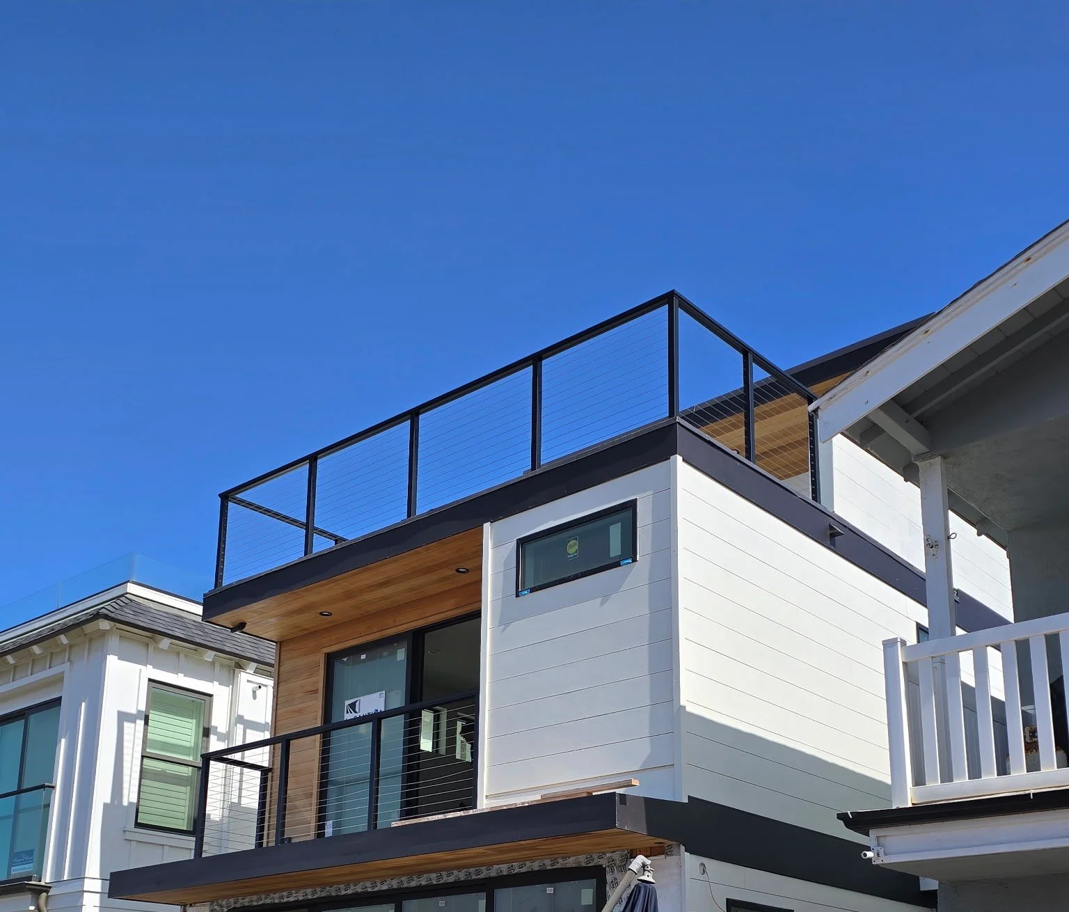 Rooftop deck cable railing system installed by Picano Builders in Newport Beach, designed to preserve coastal views while providing modern safety and durability.