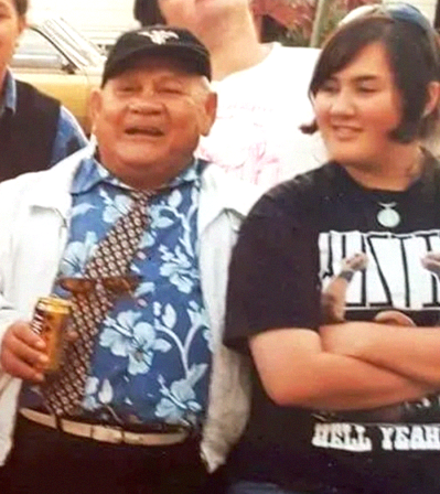 Samoan grandfather smiling with teenage granddaughter