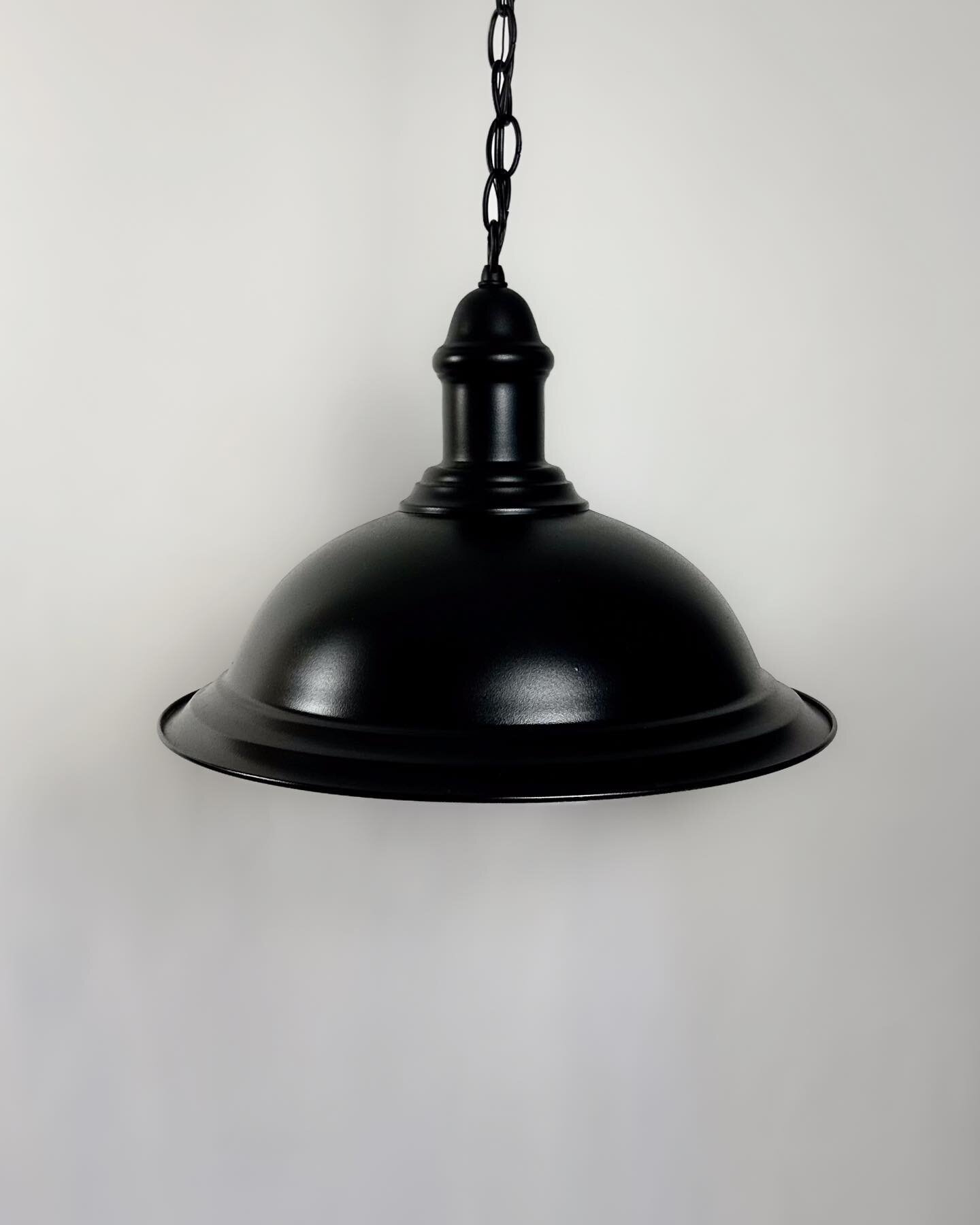 This striking vintage matte black pendant light features a chain and white interior. Check our website for printing and detail.