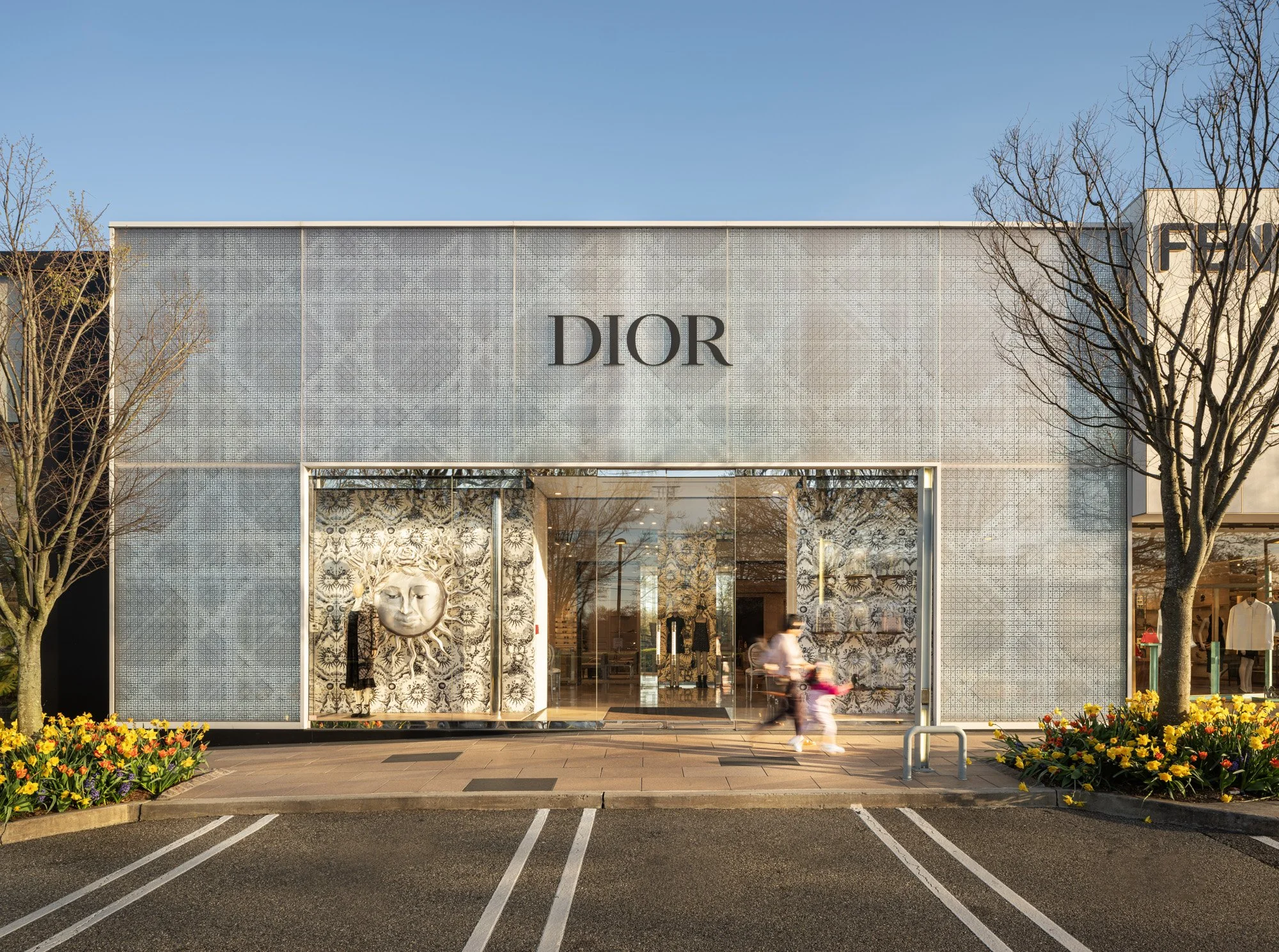 Luxury storefront facades at Americana Manhasset including Dior, David Yurman, Ralph Lauren, Fendi, Lafayette 148, Scanlan Theodore, LoveShackFancy and Todd Snyder — retail architectural photography across seasons by Pavel Bendov, Manhasset NY
