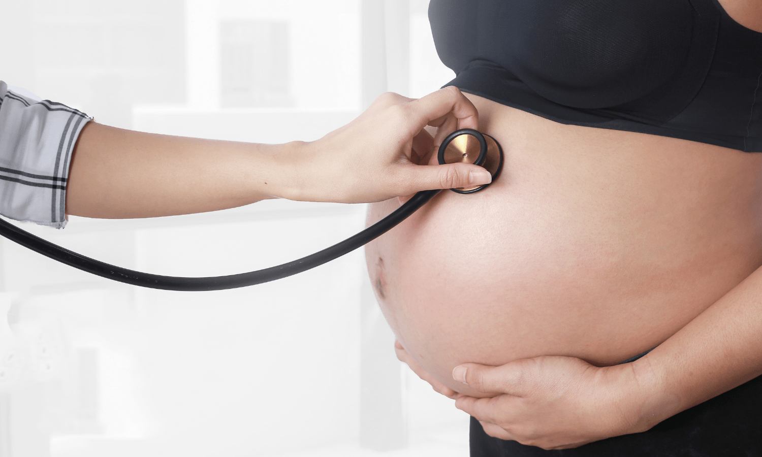 Doctor checking on patient to see if uterine fibroids impacted her pregnancy.