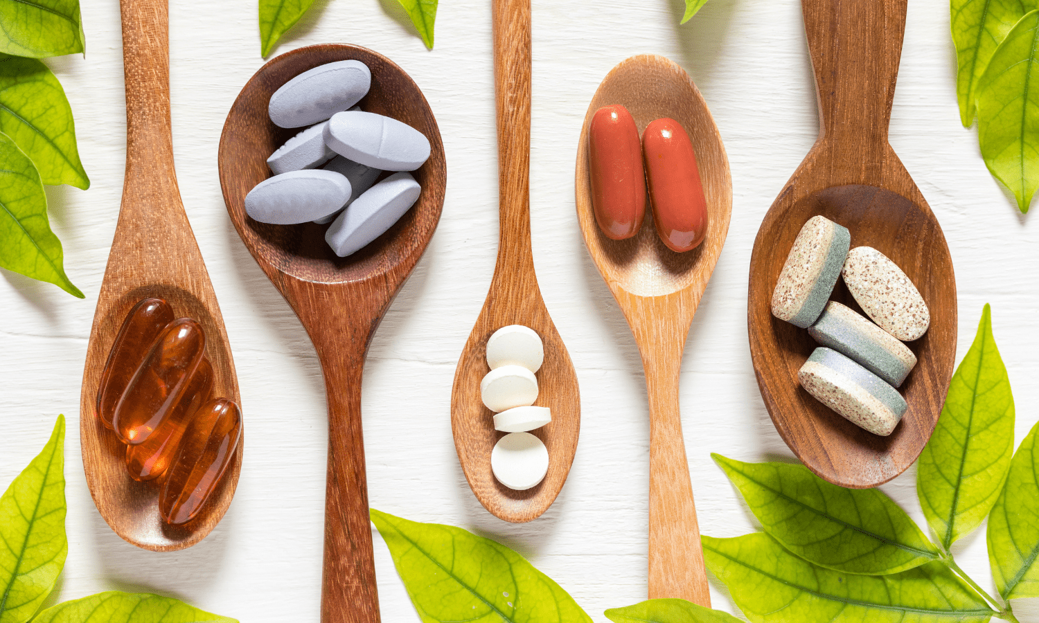 A wooden spoon displaying various types of pills and capsules for varicose veins treatment.