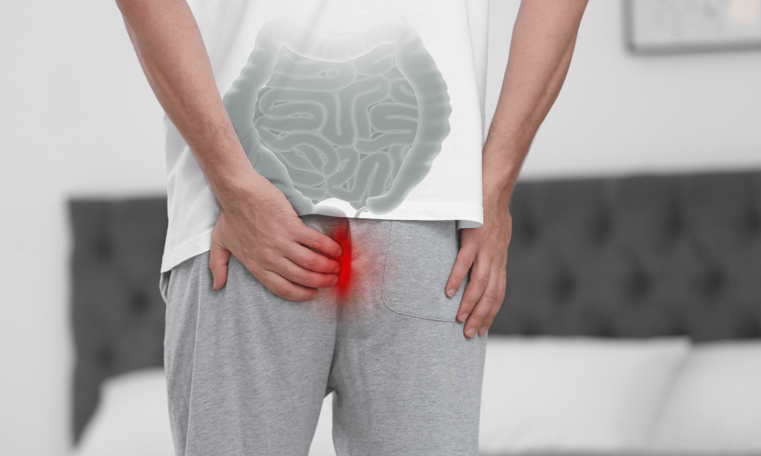 A man is holding his stomach with a red mark on it, possibly indicating hemorrhoids.