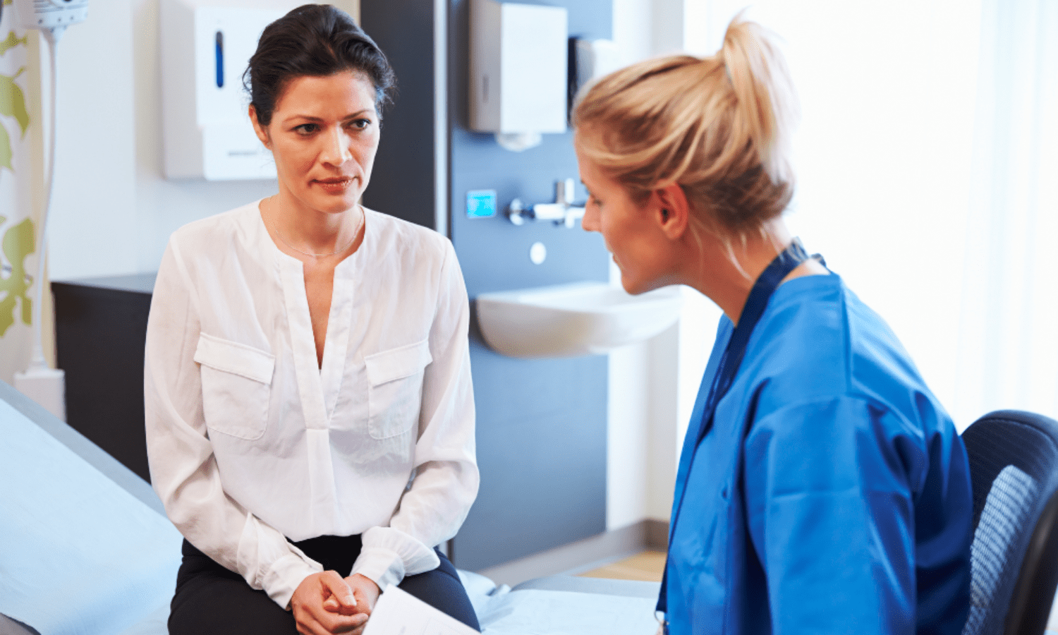Doctor explaining to patient whether or not uterine fibroids are cancerous.