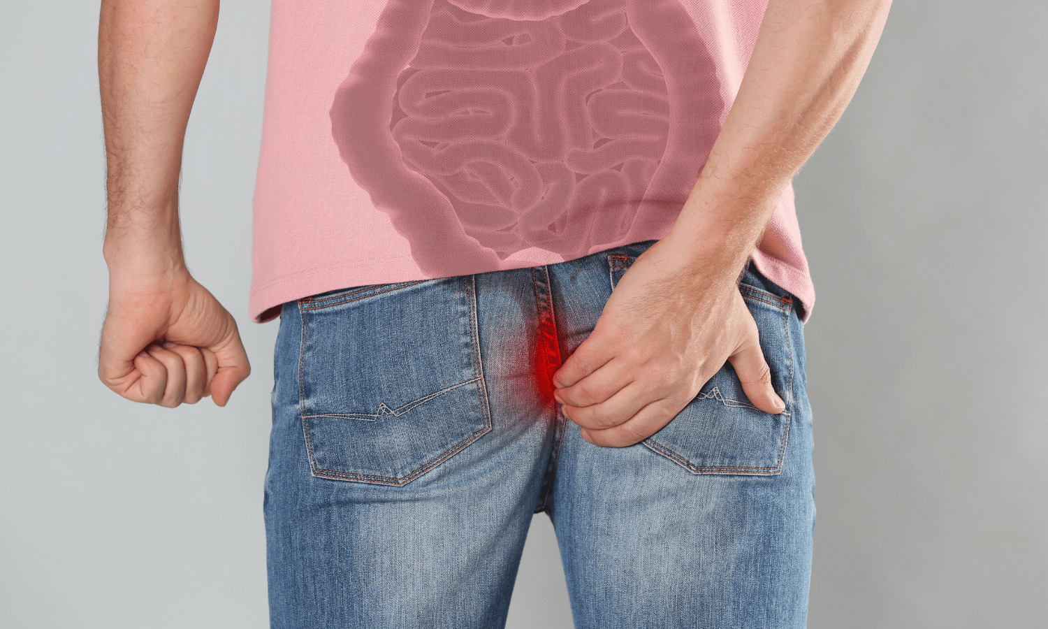 A man in jeans highlighting the causes of hemorrhoids.