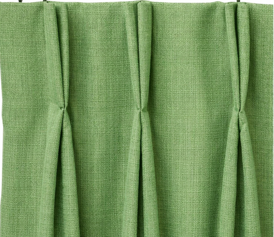 Close-up of green fabric curtains - heading double pinch pleats.