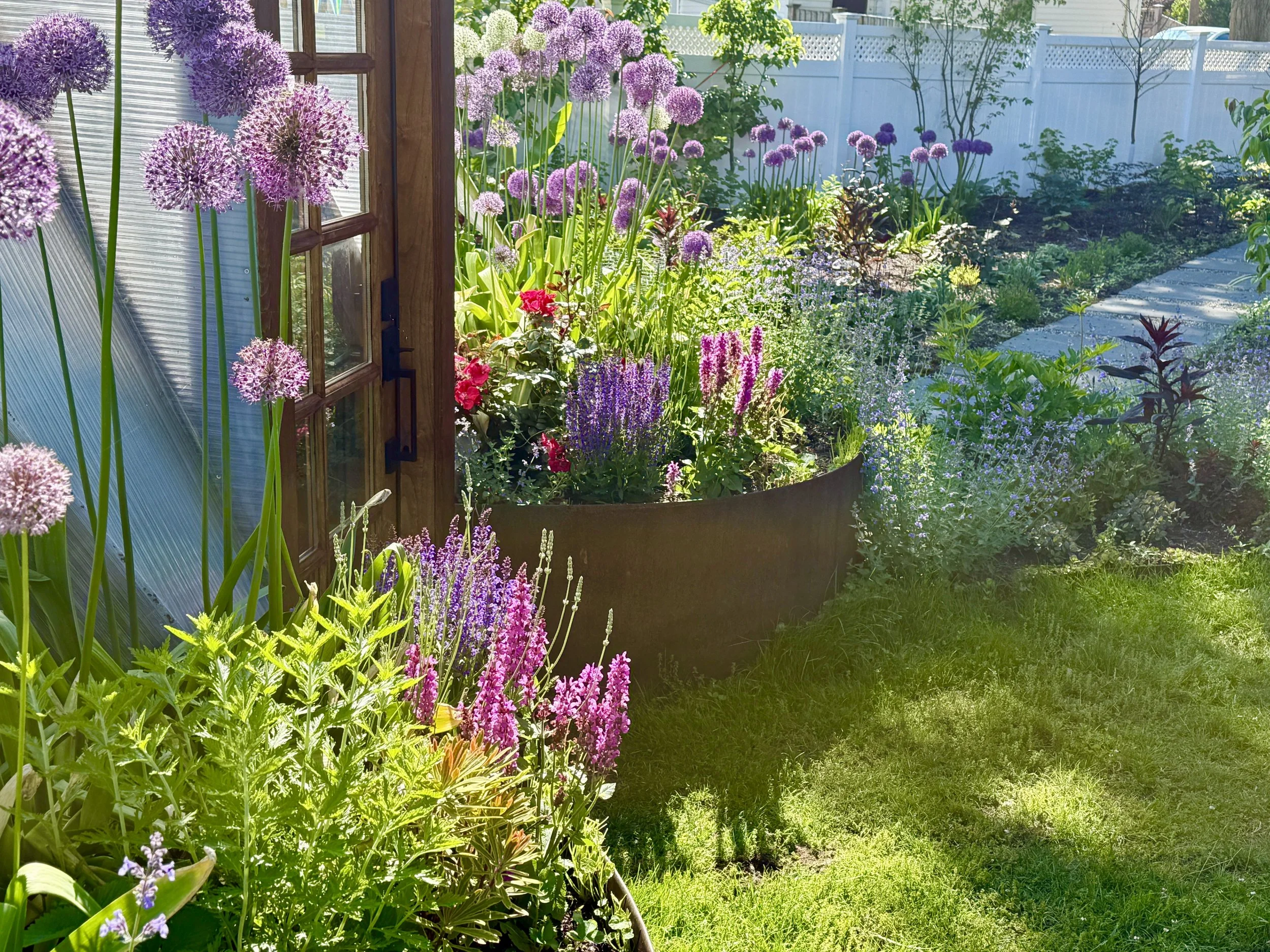 Flower garden, allium bulbs, geodesic dome greenhouse, mixed edible plants.jpg