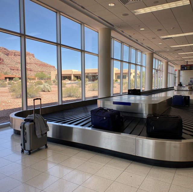 Driver waiting at airport arrivals with delayed flight board