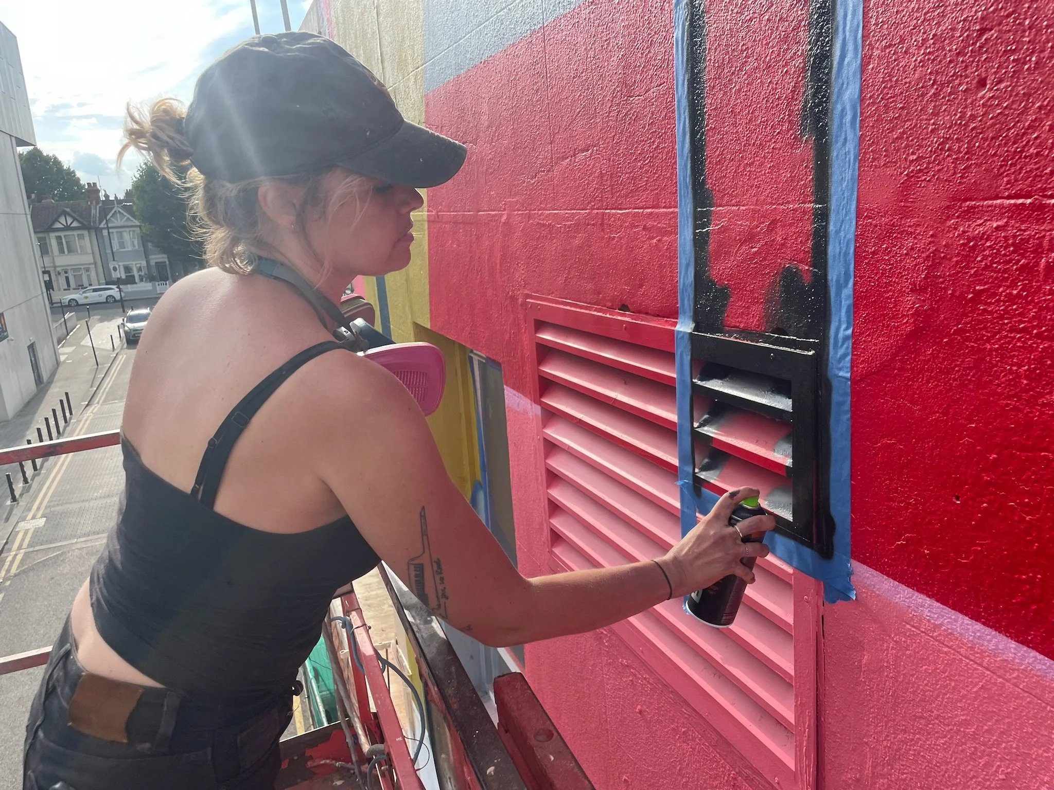 Mural artist Ansley Randall creating a large-scale architectural artwork at Southend City Jam 2026.