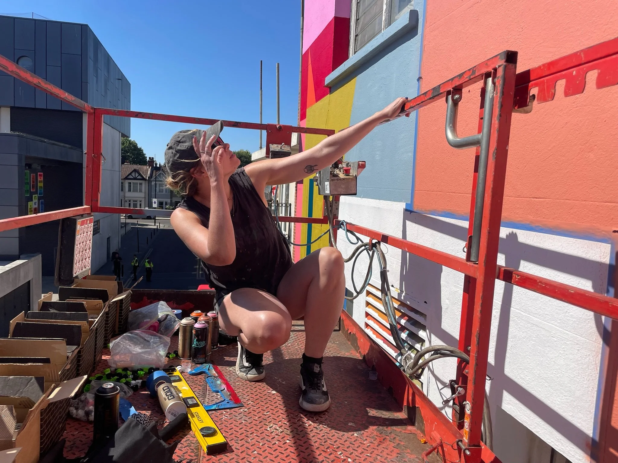 Mural artist Ansley Randall creating a large-scale architectural artwork at Southend City Jam 2026.