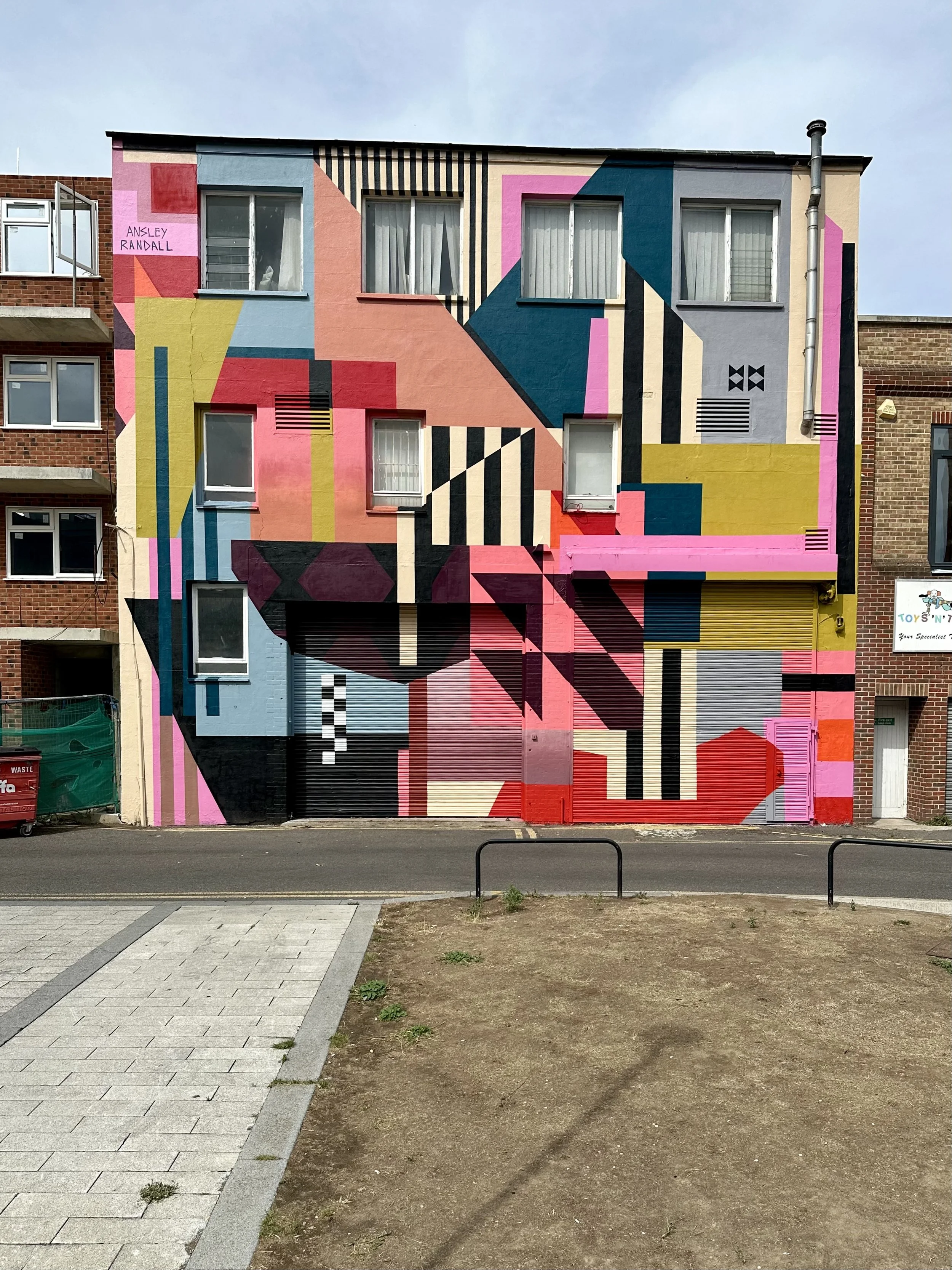 Bold mid-century-inspired shapes, colorful stripes, and geometric patterns in Ansley Randall's Southend mural.