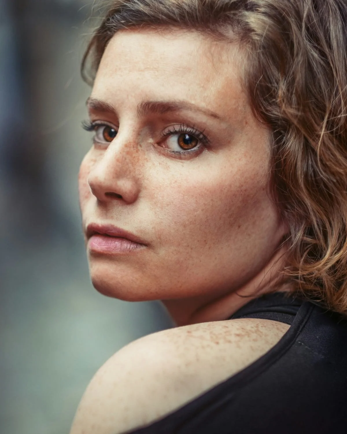 Woman looking over shoulder experiencing postpartum separation anxiety therapy in Miami FL