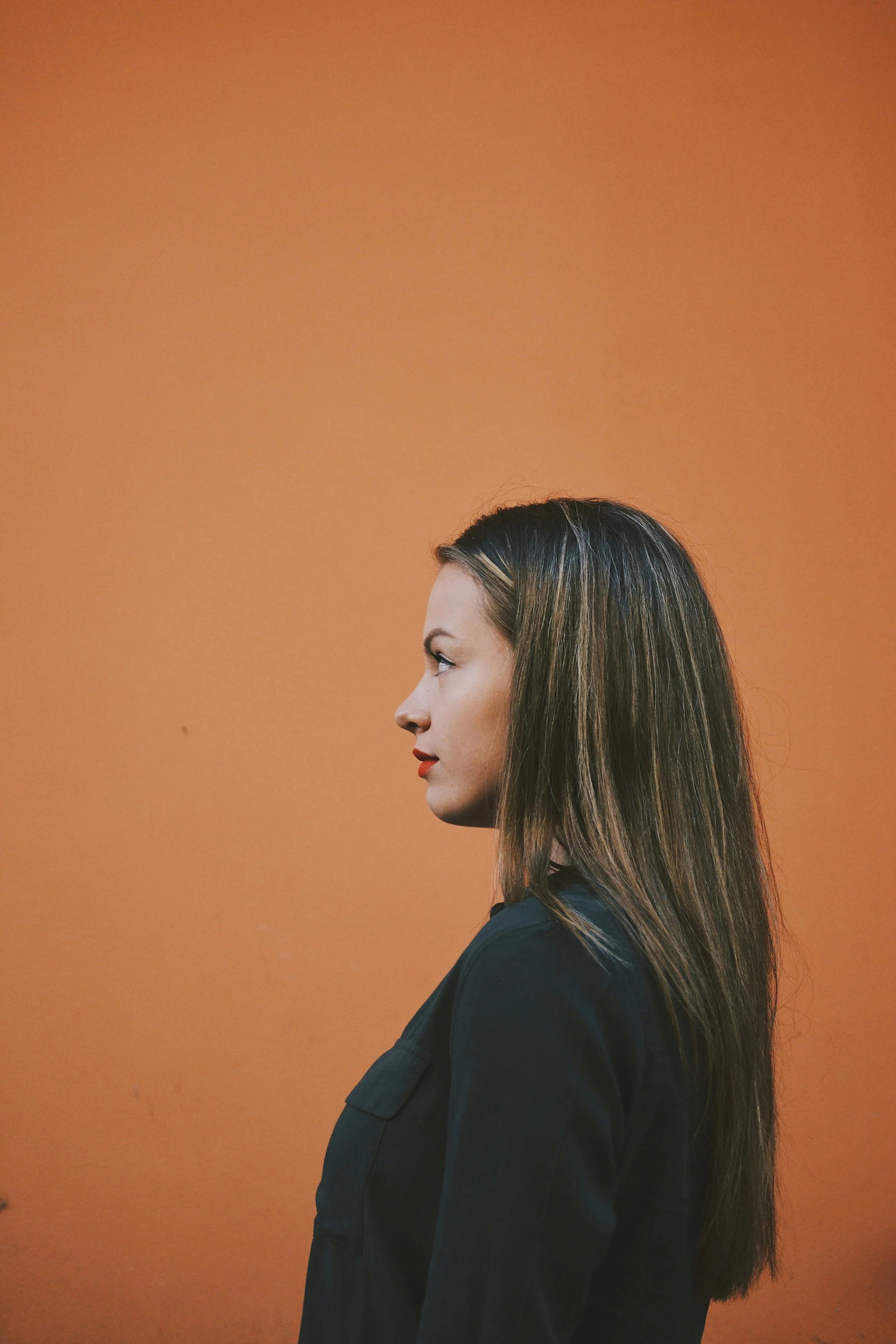 Latina woman looking away during pregnancy loss therapy session in Miami