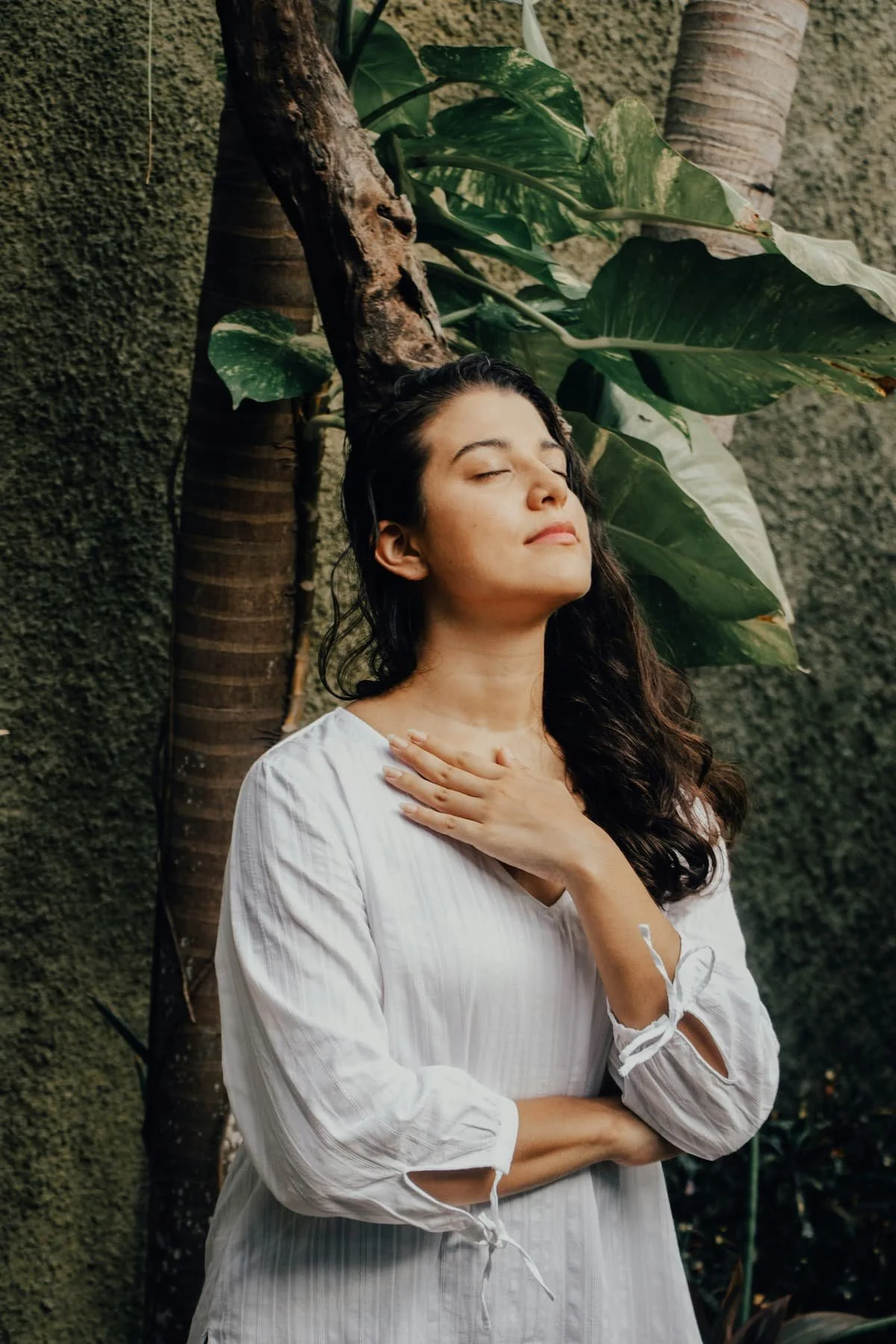 Woman hand on chest finding peace after birth trauma therapy in Miami FL