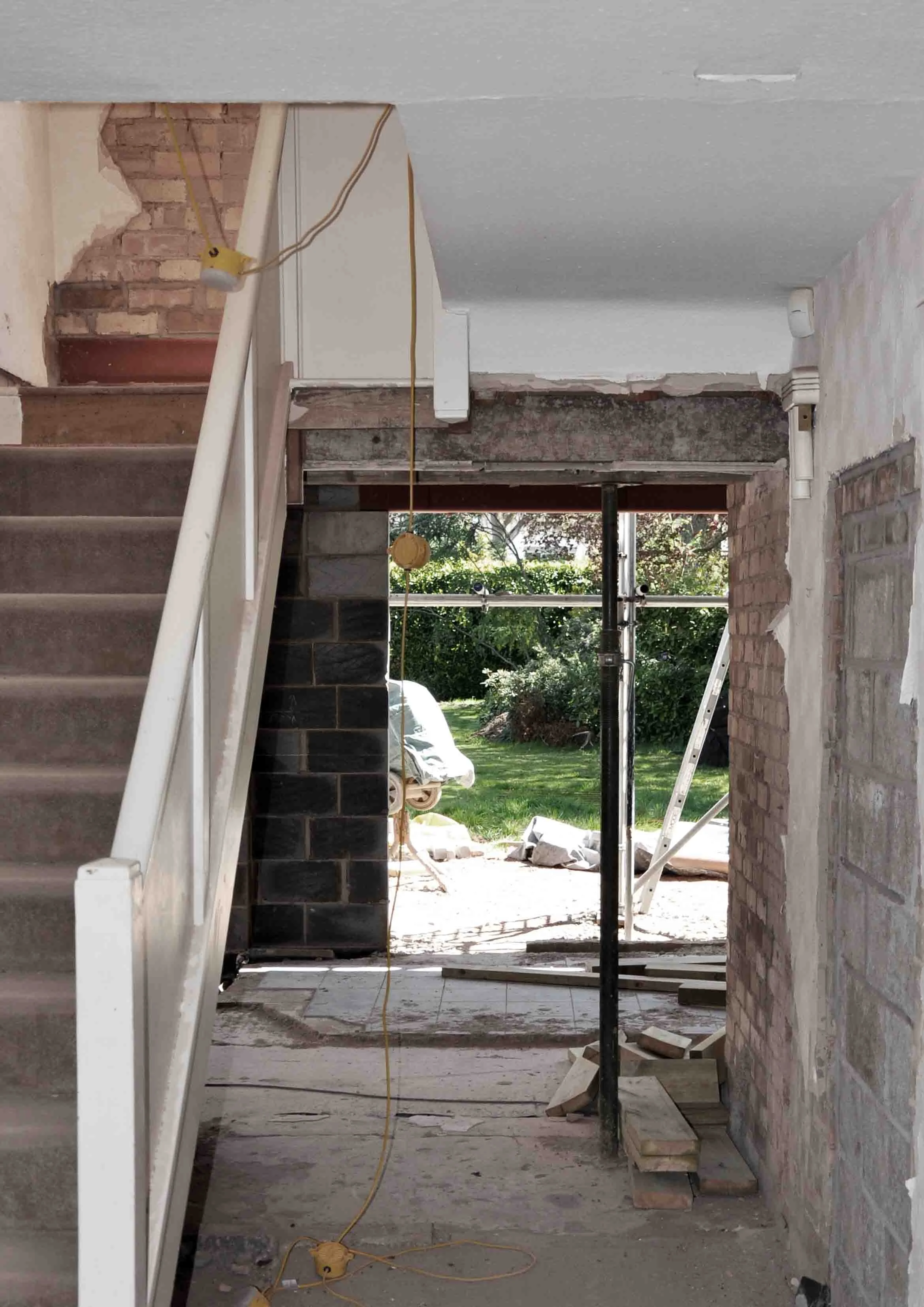 Construction photograph showing structural adaptation to entrance hall with visual sightlines to private rear garden space by Unity Architects Leamington Spa