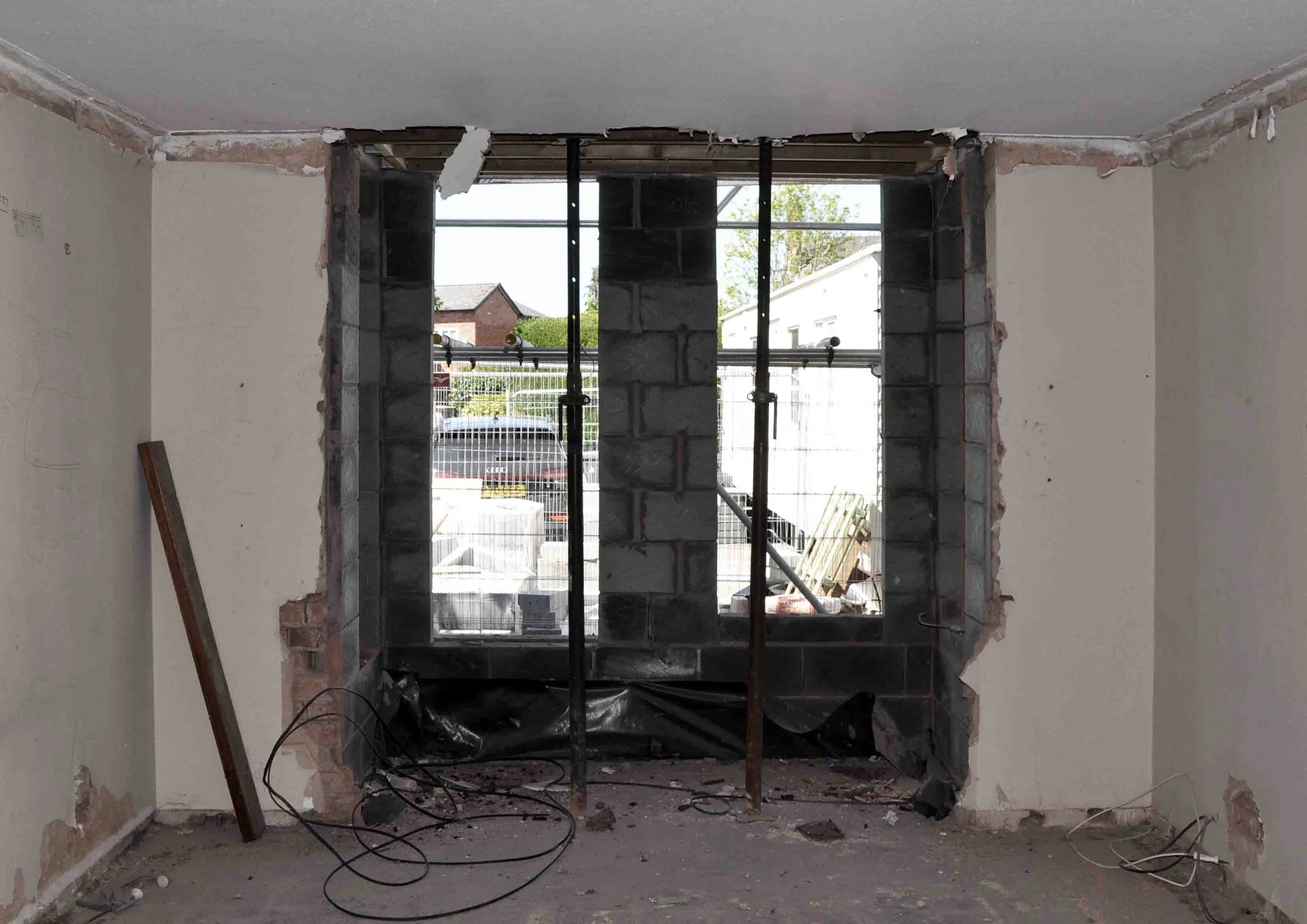 Construction photograph showing temporary acrow props as we create new bay windows with Georgian proportions by Unity Architects Leamington Spa