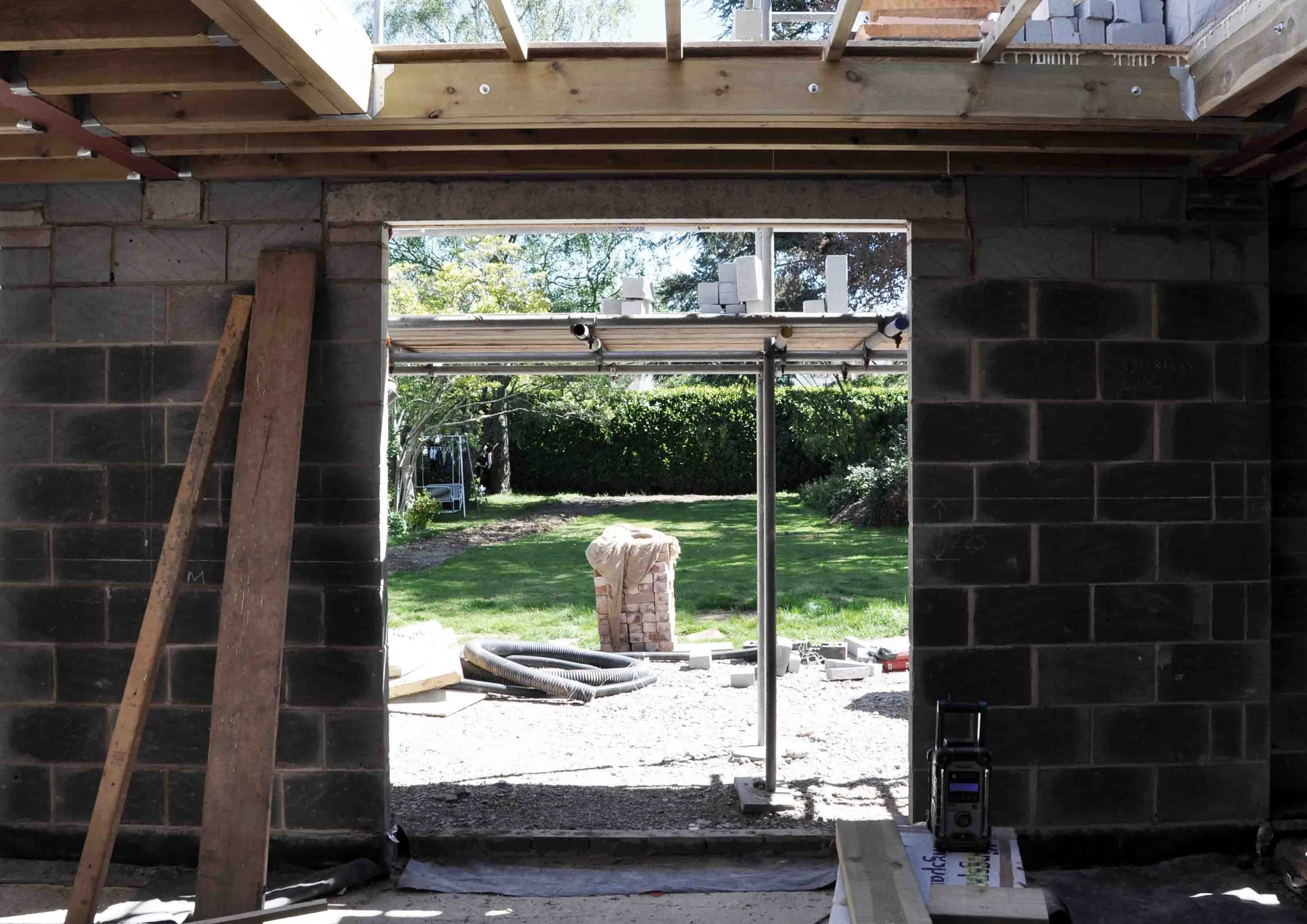 Construction photograph showing rear extension with large structural apertures linking to rear garden by Unity Architects Leamington Spa