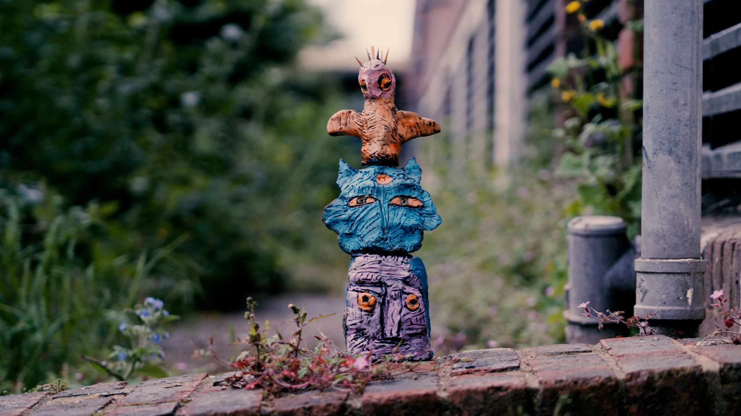 Violet's cat totem sculpture outside on step.jpg