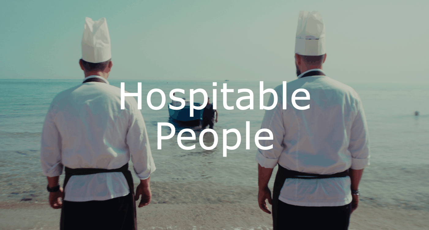 Two chefs waiting for fisherman to arrive.