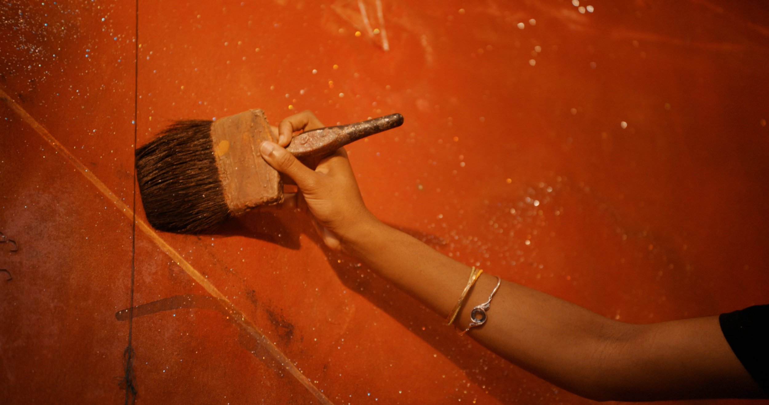 Frank Bowling hand and paintbrush.jpg