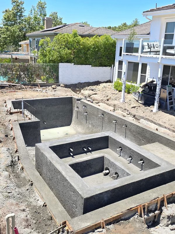square pool with raised spa and baja