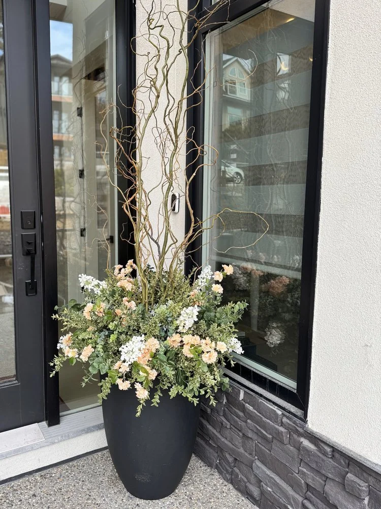 A  seasonal container insert with spring foliage, botanical textures, and garden-inspired accents.