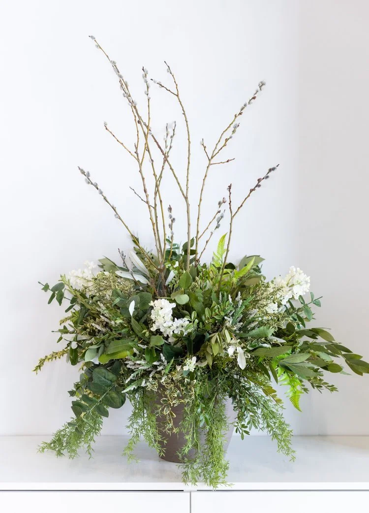 Spring planter arrangement with evergreens, dried florals, and faux accents in a 12" container for outdoor seasonal décor.