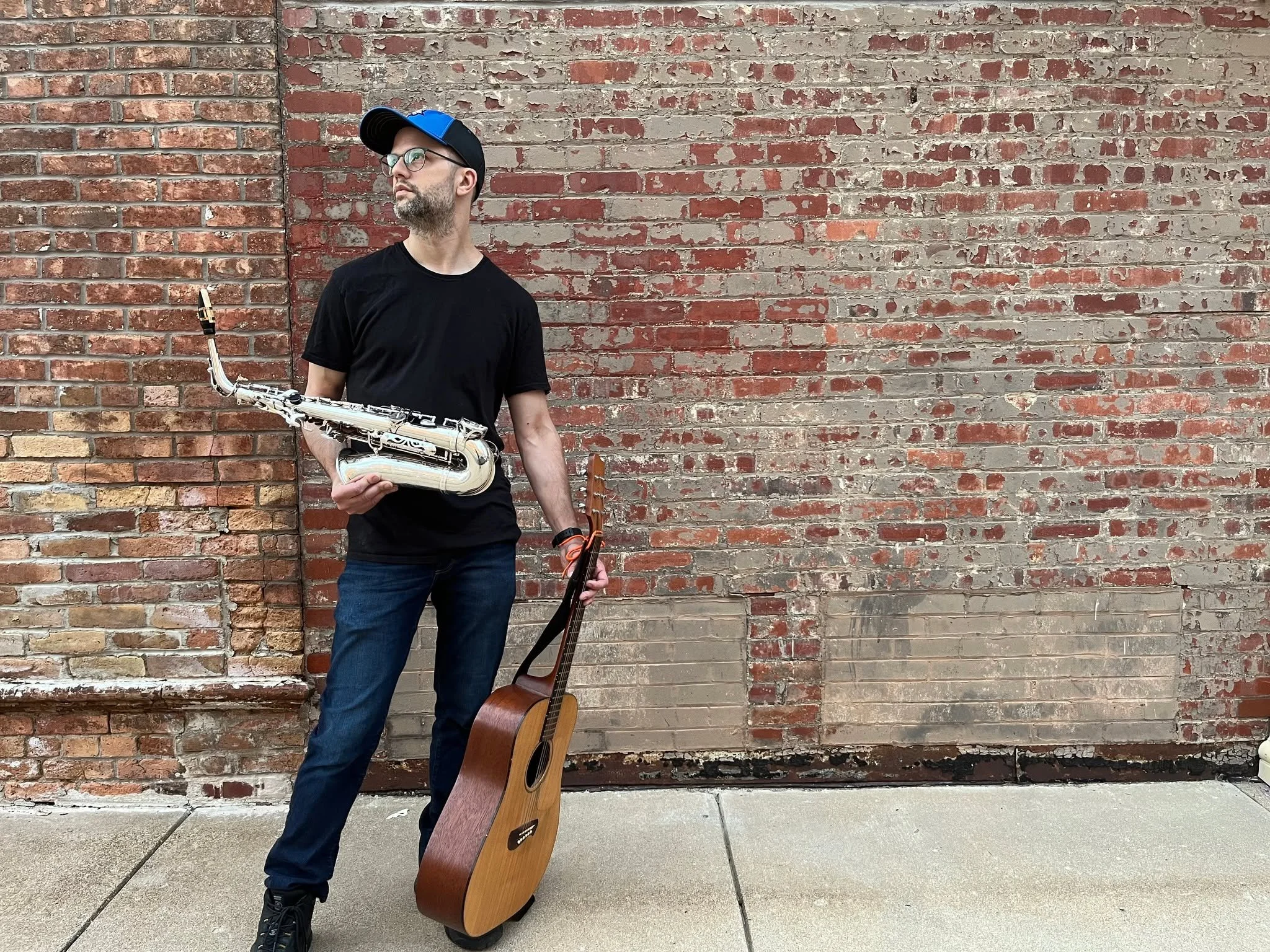 📸 This past summer we did a little photoshoot  in downtown Bloomington and managed to snap this candid of Chris looking like he somehow plays both saxophone and guitar simultaneously.... should he give it a shot? 😋😂