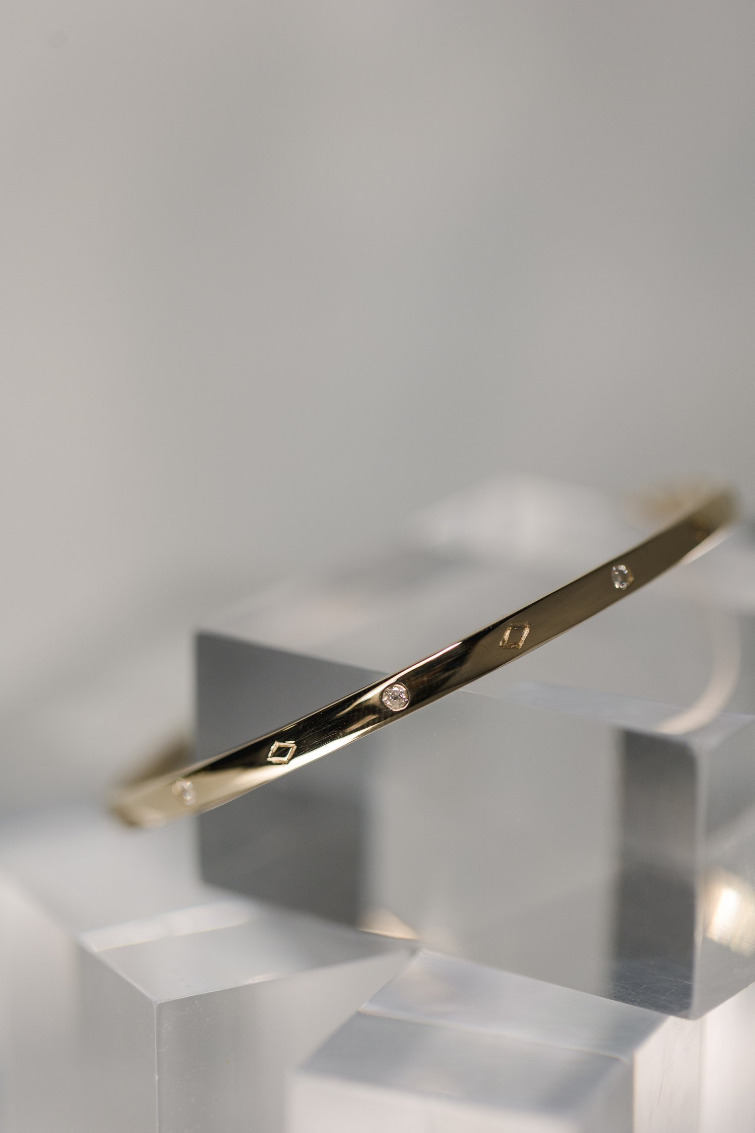 custom made recycled solid yellow gold bangle with engraving and diamonds designed by Alexandria &amp; Company fine jewelers