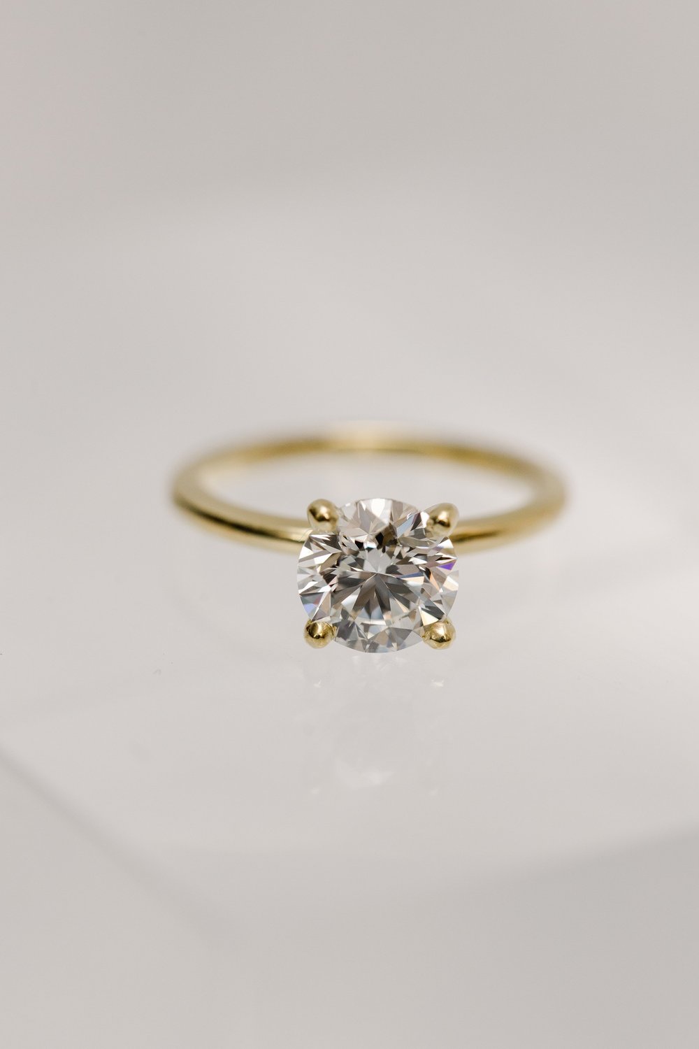 custom designed brilliant cut solitaire diamond engagement ring in four prong yellow gold setting made by Alexandria &amp; Company in Old Town Alexandria