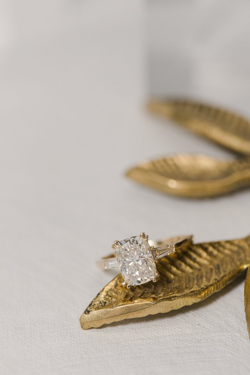 Custom designed radiant cut diamond engagement ring featuring accent baguette cut diamonds set in yellow gold made by Alexandria &amp; Company in Old Town Alexandria 