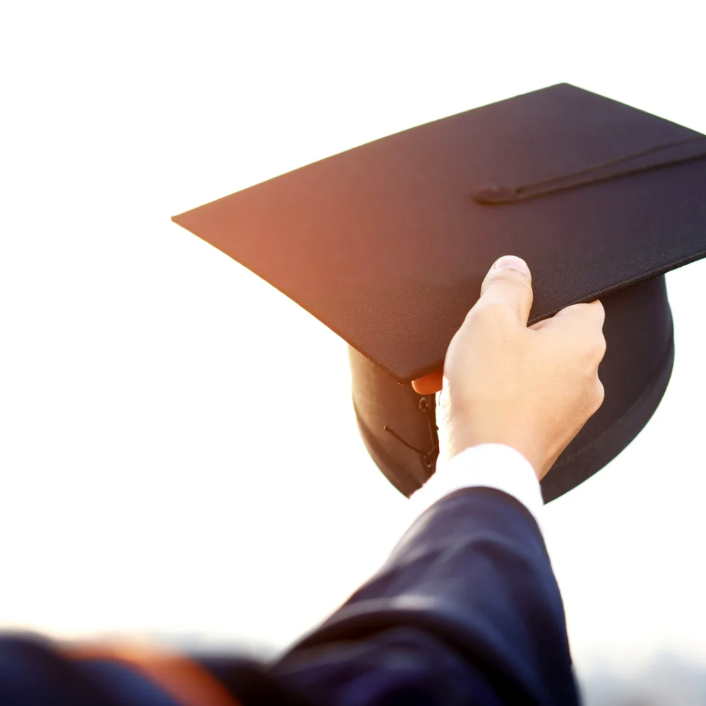 graduate tossing hat in air
