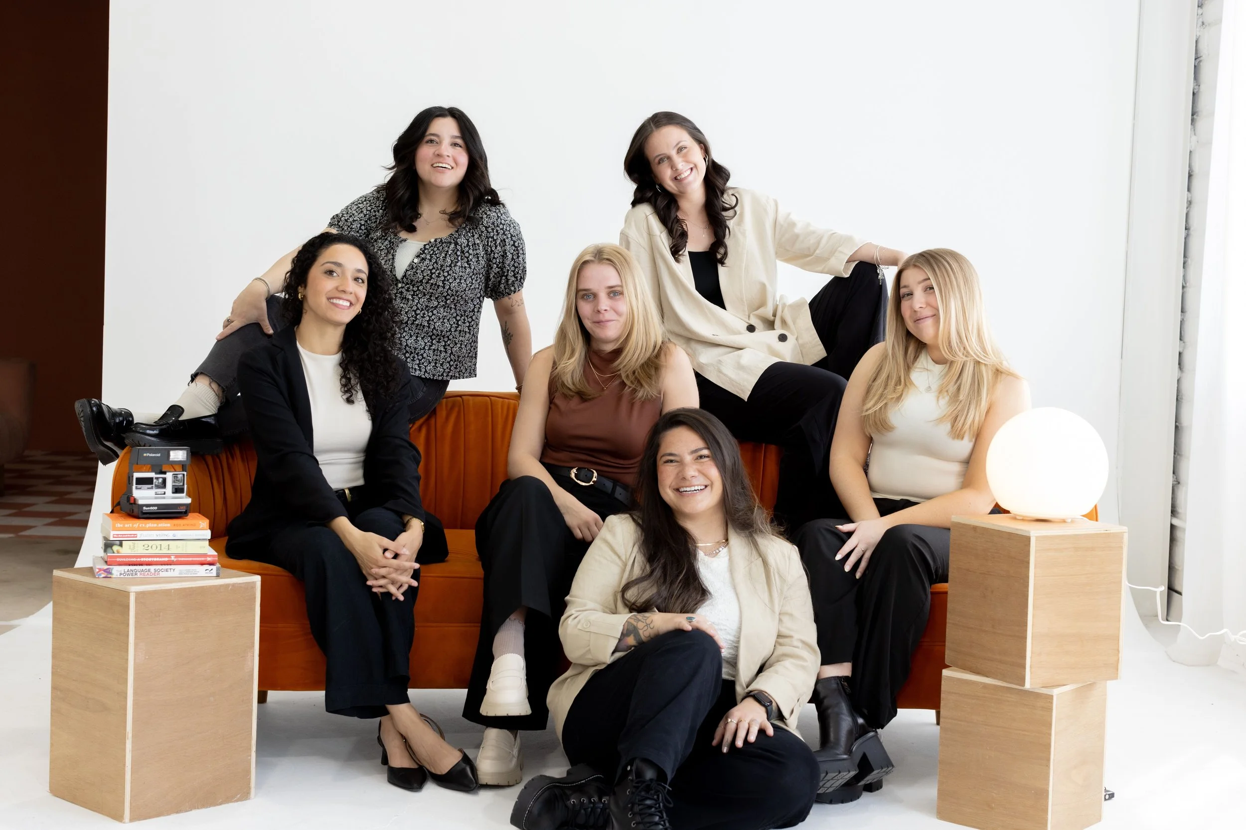 Cucamonga Media team photo on an orange couch