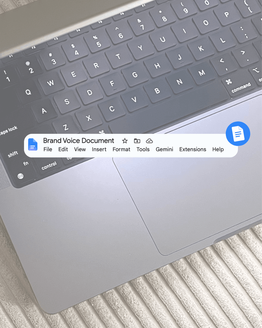 Close-up of a laptop keyboard with a Google Docs file titled 'Brand Voice Document' overlaid on screen.