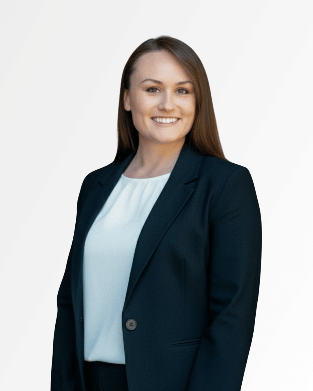 Professional woman with long brown hair smiling, wearing a navy blazer over a white blouse, standing against a light gradient background.