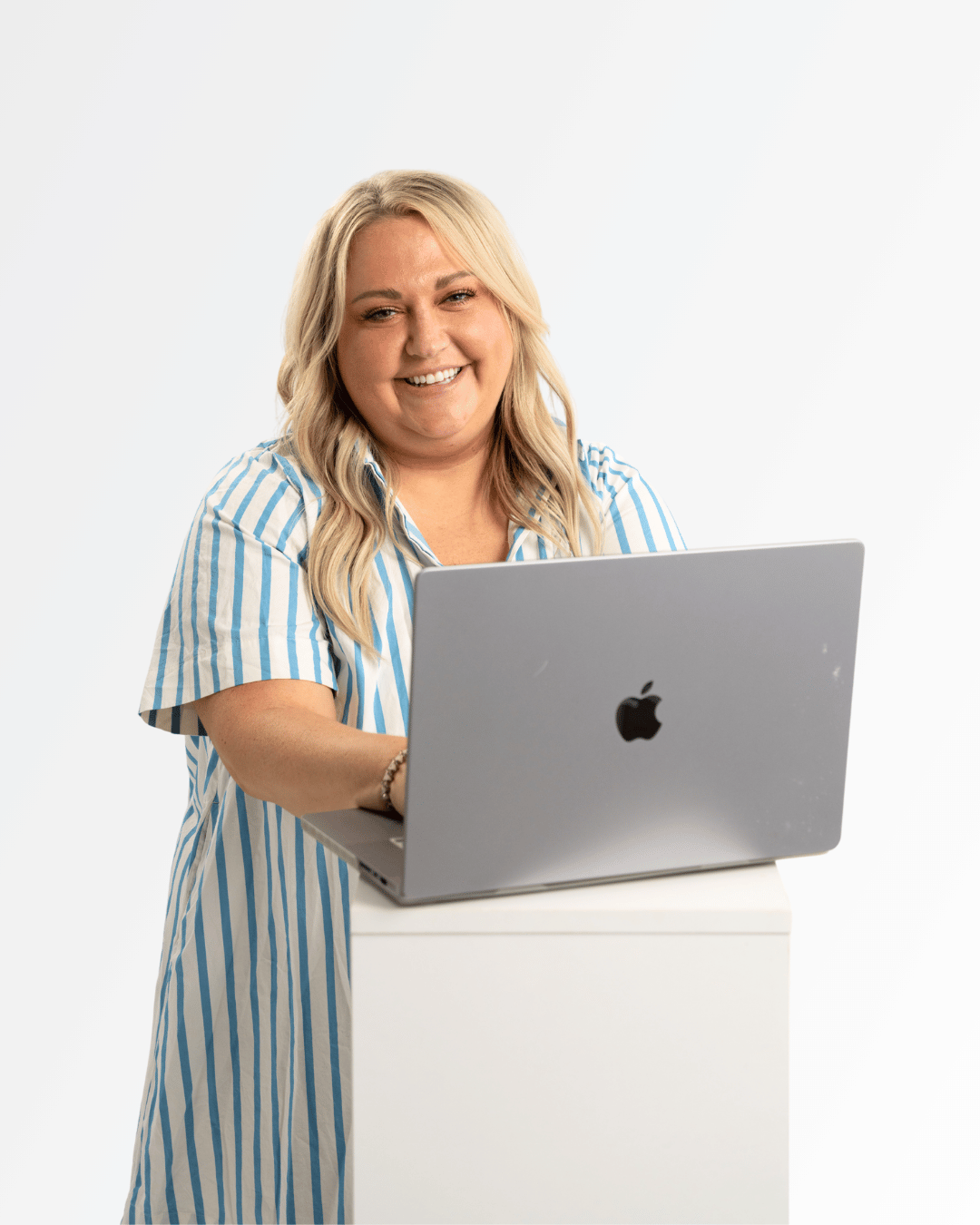 Portrait of Cucamonga Media Social Media Specialist, Kimberly with a macbook