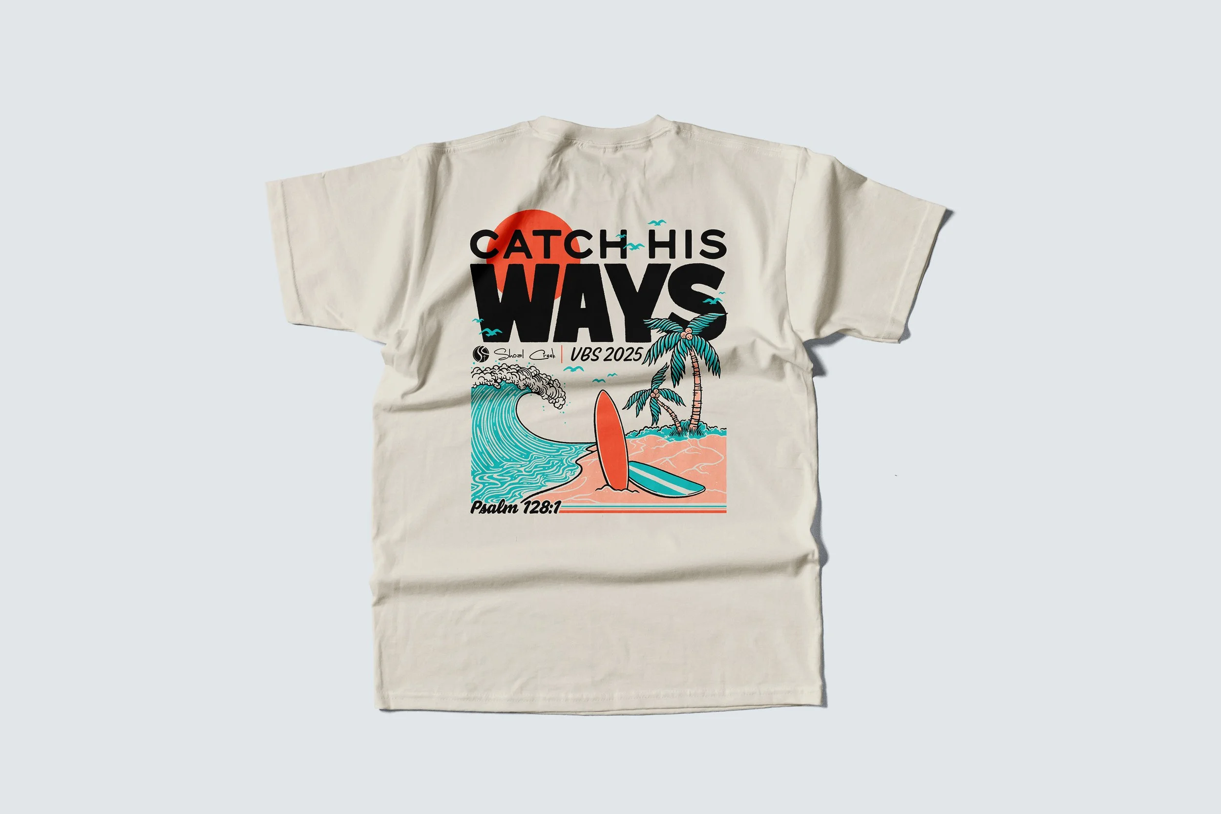 A white T-shirt with a colorful graphic design featuring a surfboard on sandy beach, palm trees, ocean waves, seagulls, and sunset, with the text 'Catch His Ways' and references to 'VBS 2025' and a Bible verse 'Psalm 128:1'.