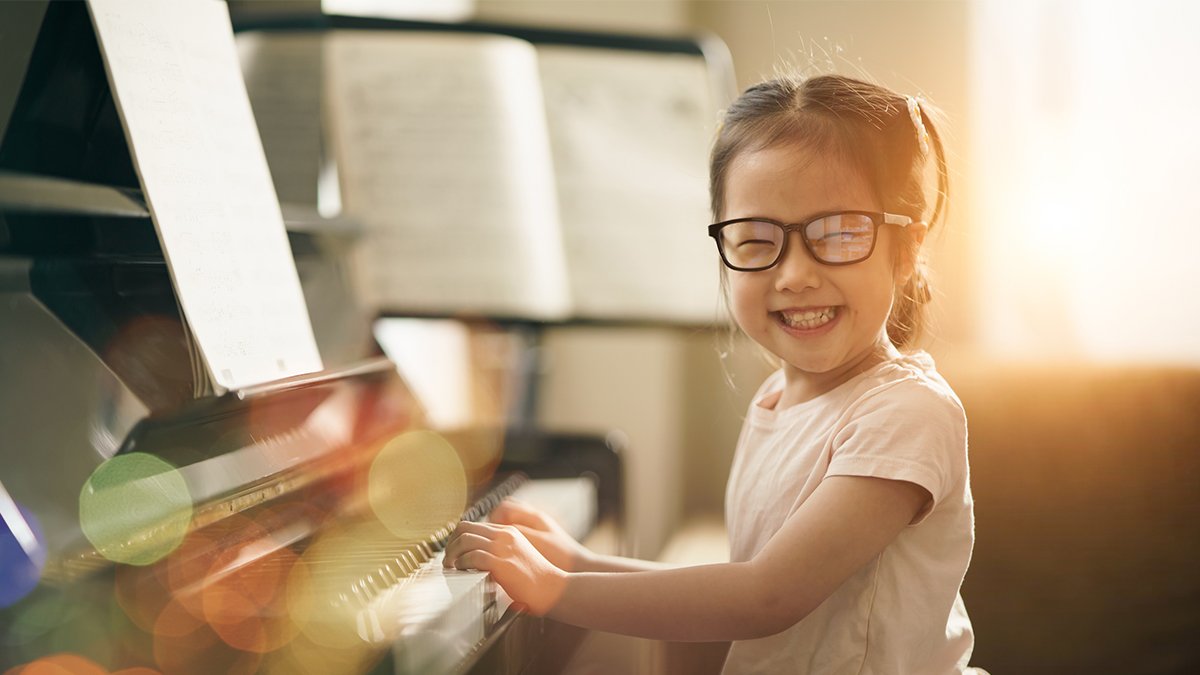 happy child at the piano