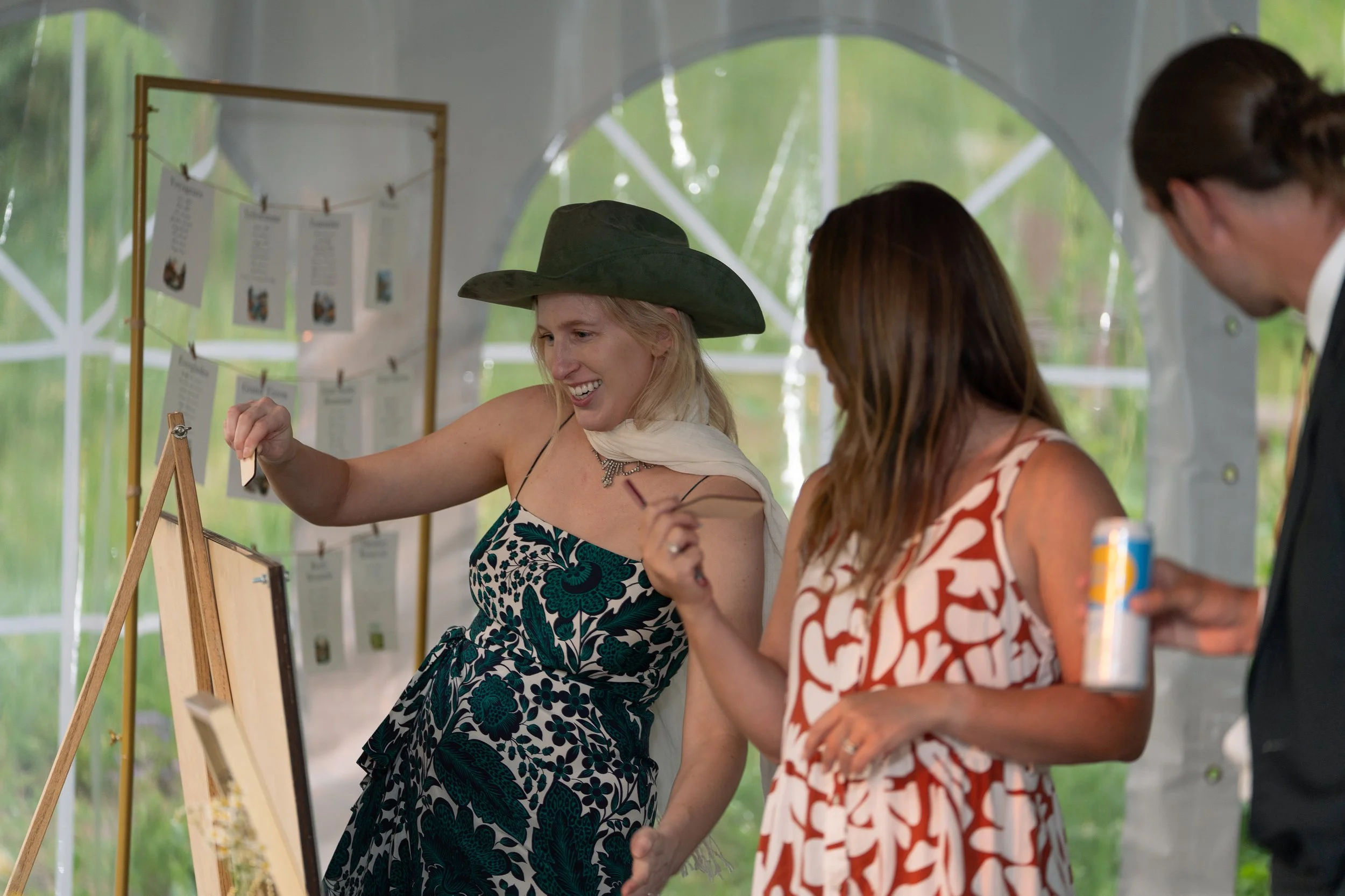 Grand Targhee Resort, documentary Wedding photography; guests at reception putting written messages on wooden board