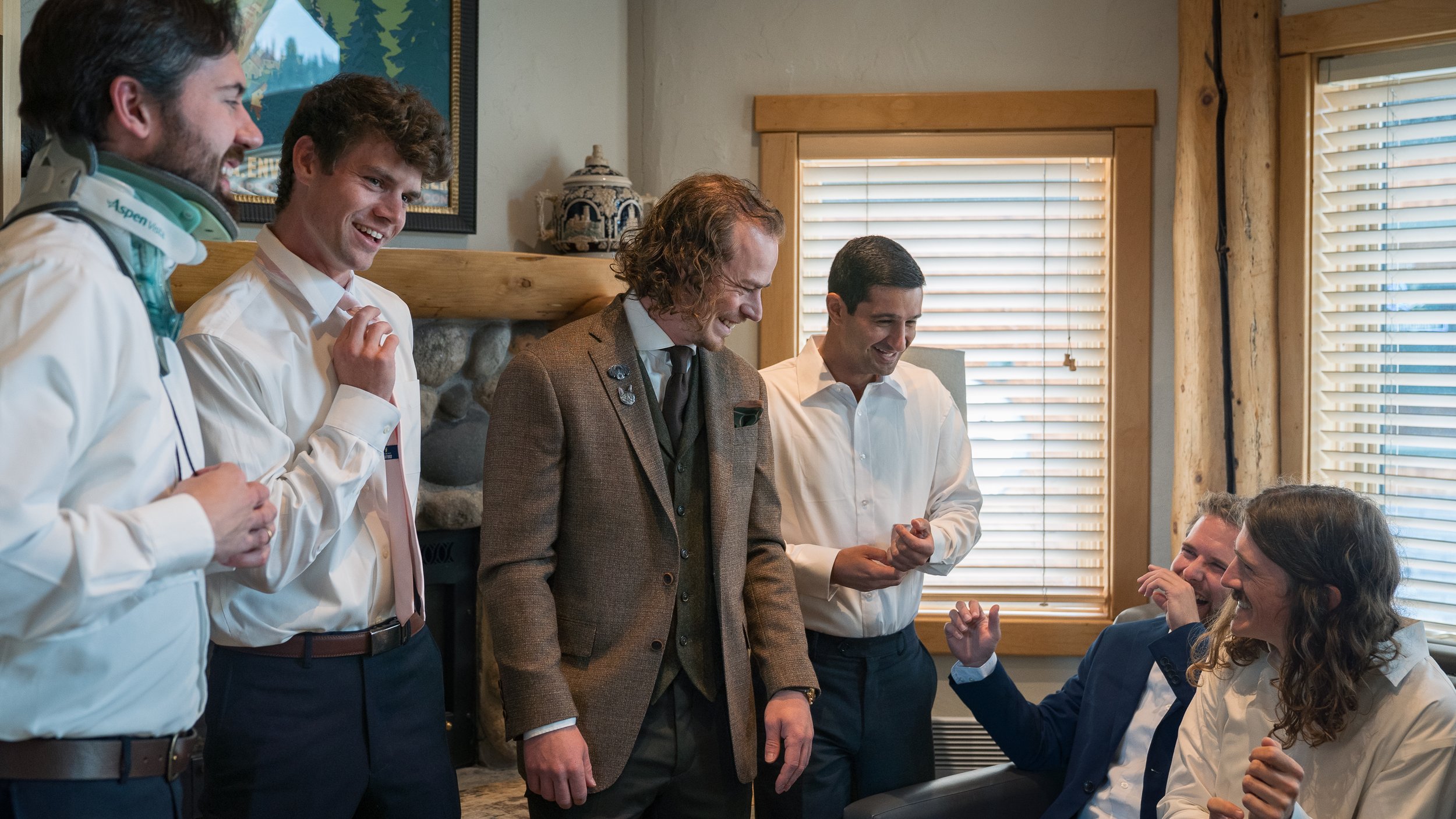 Groom and groomsmen celebrating while getting ready