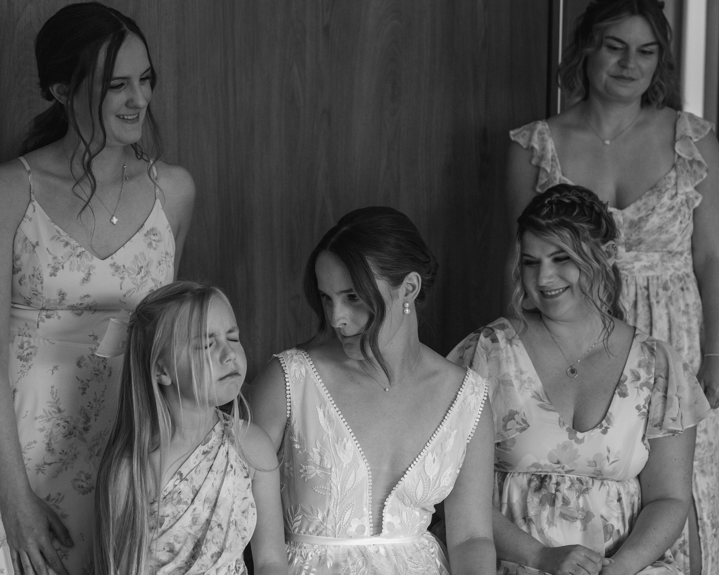 Bride and maids getting ready, flower girl making a funny face in bridal suite at Grand Targhee Resort, documentary wedding photography