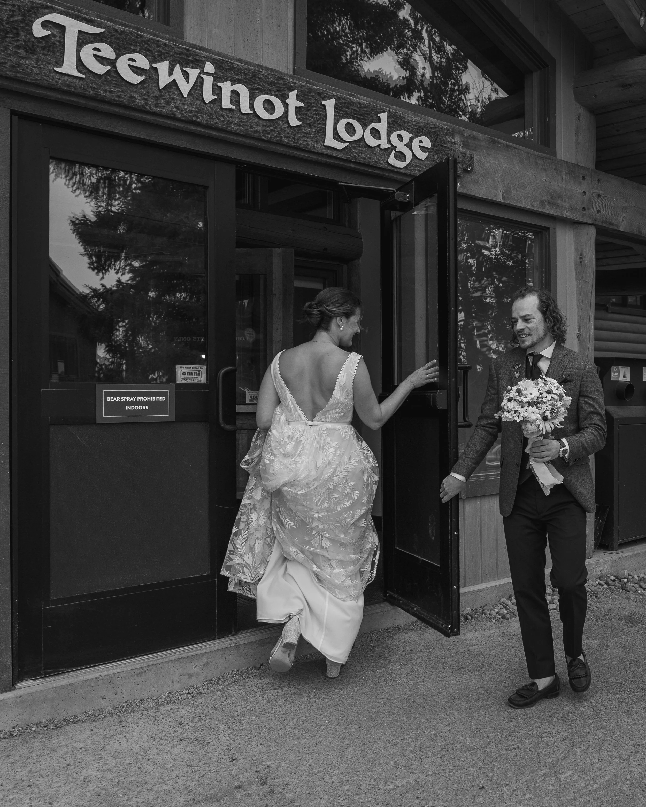 Grand Targhee Resort, documentary Wedding photography; Groom holds door for bride as they enter the Teewinot Lodge at Grand Targhee Resort