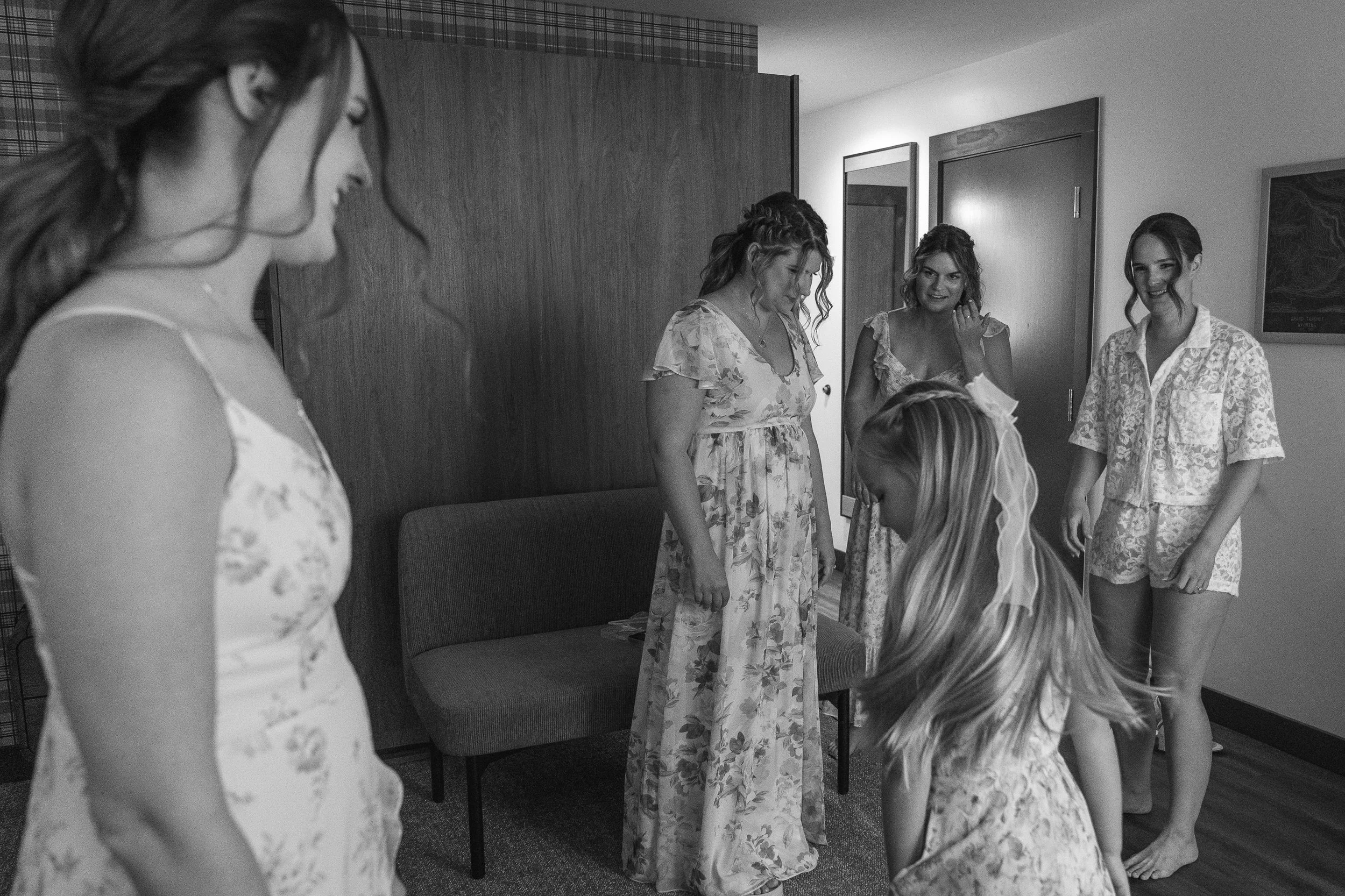 Bride and bridesmaids dancing and getting ready in bridal suite at Grand Targhee Wedding
