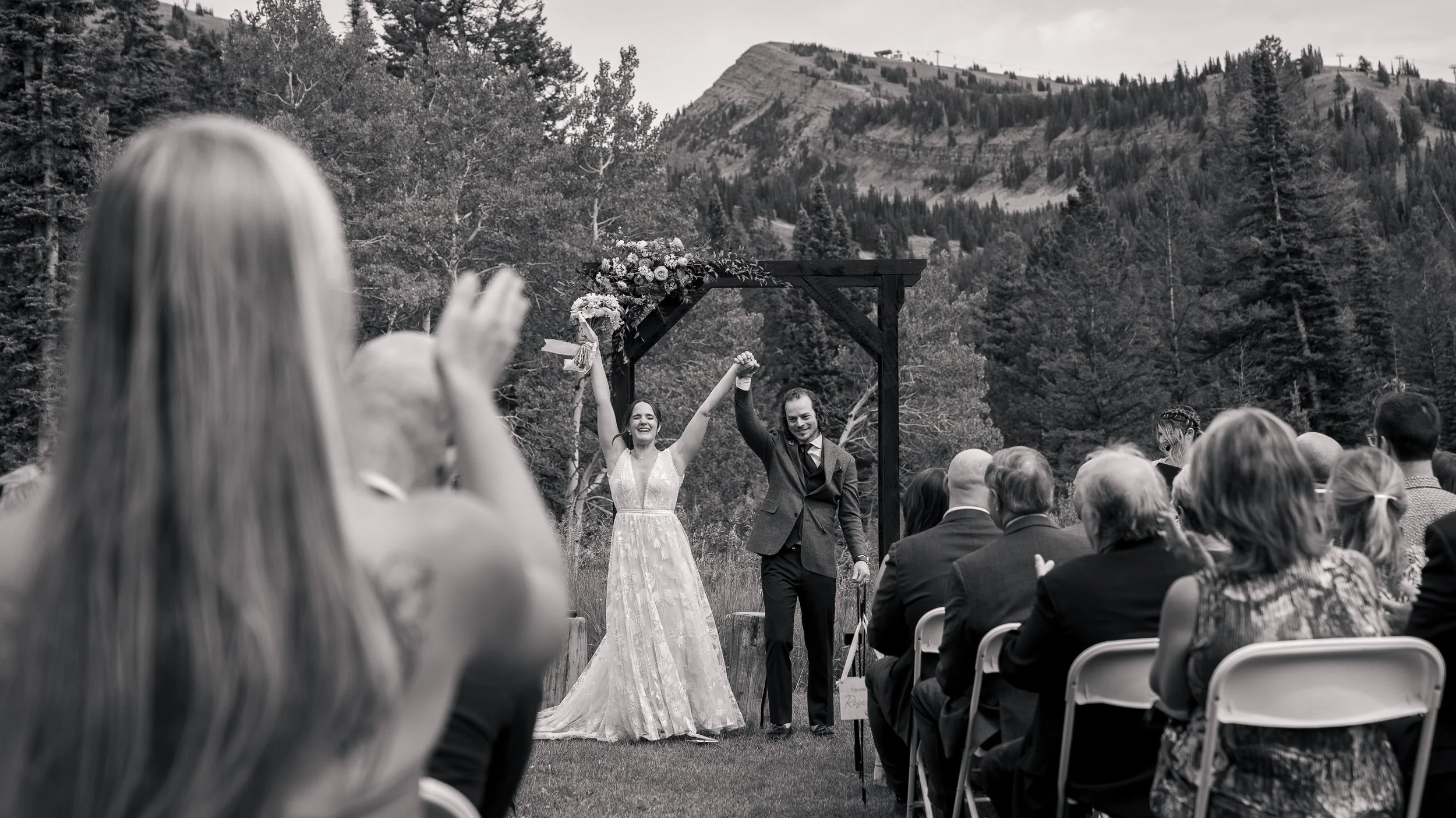Grand Targhee Resort, documentary Wedding photography; bride and groom hold hands up as they've just been pronounced husband and wife