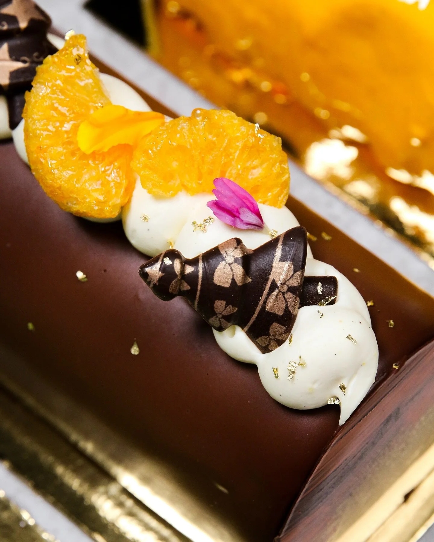 Highlighting the classic combination of chocolate and citrus for the holidays ~ mandarin cake, orange whipped ganache, orange marmalade, dark chocolate mousse and rich chocolate glaze.

Our festive B&ucirc;che de No&euml;l cakes are now available for