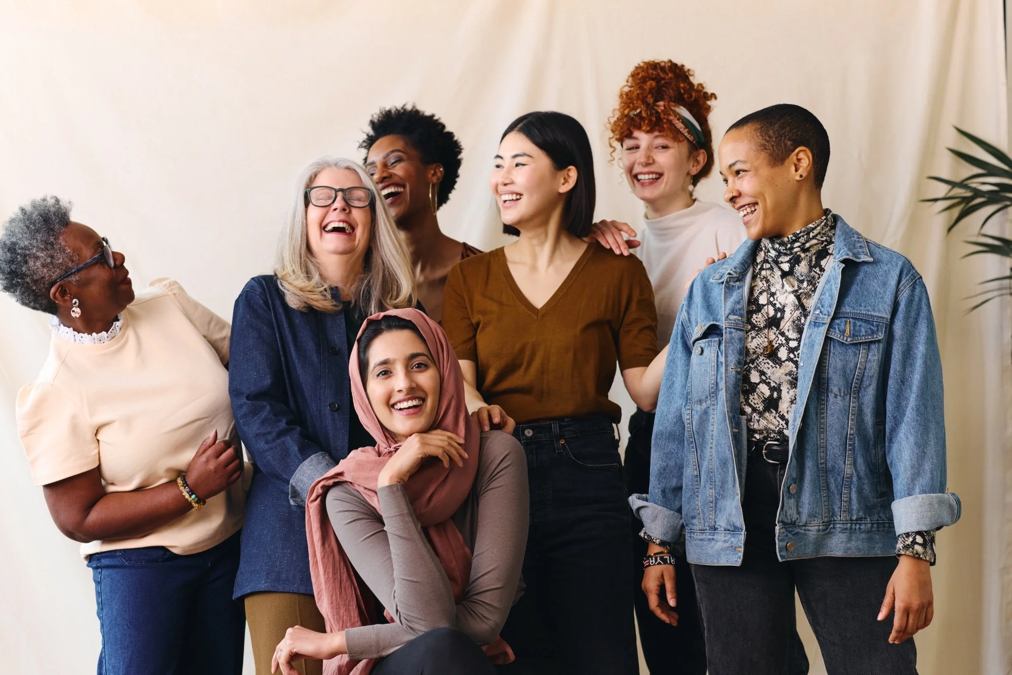 A group of diverse women by age, culture, ethnicity and race laughing and smiling