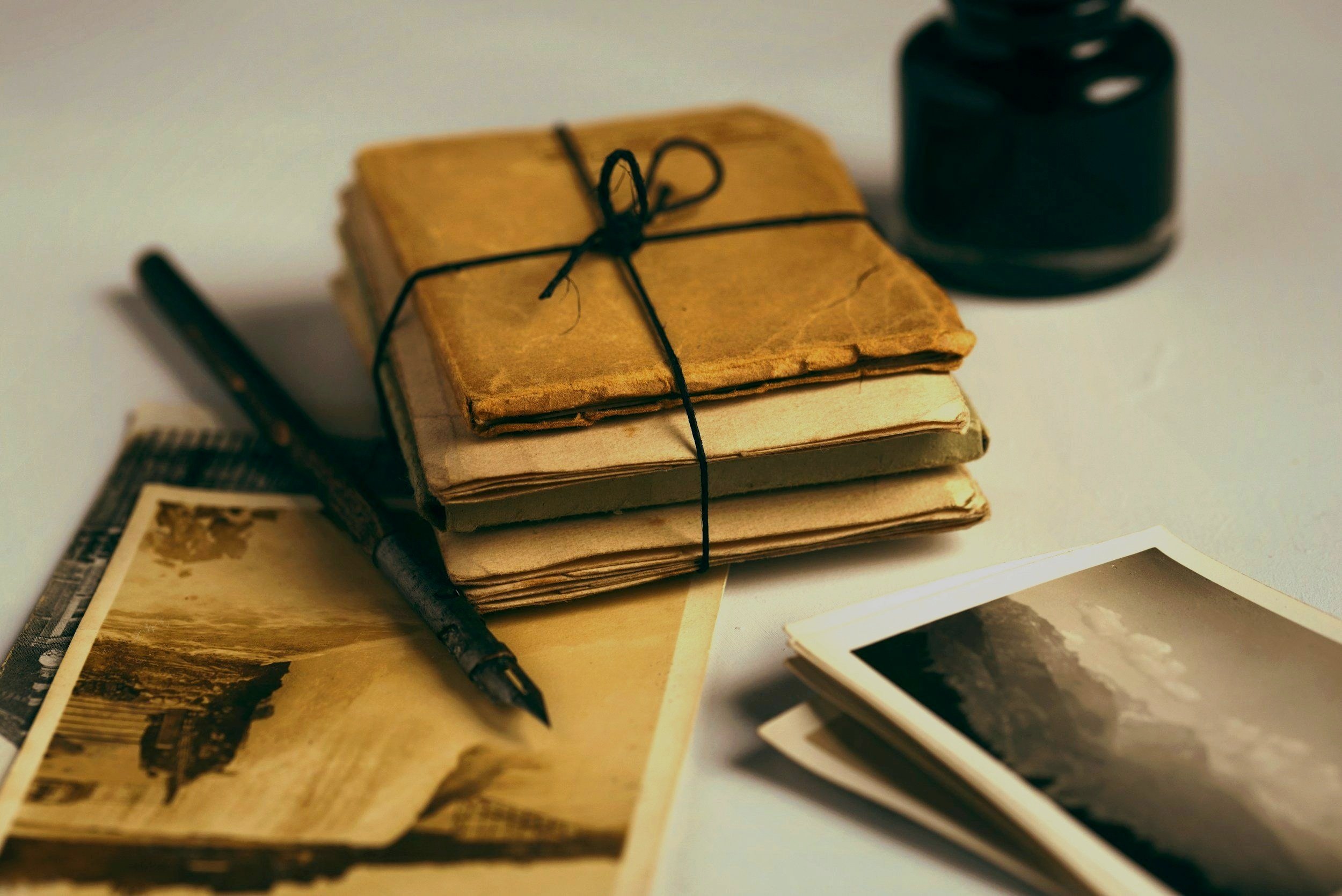 Pen, old books and photographs.