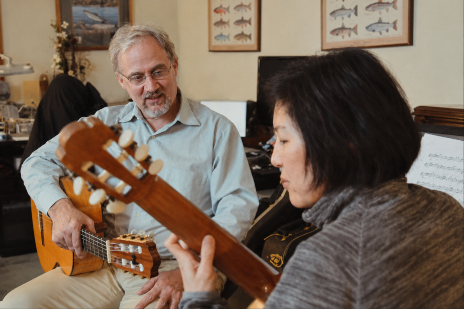 David Franzen teaching a classical guitar lesson to an adult student in his Tigard studio.