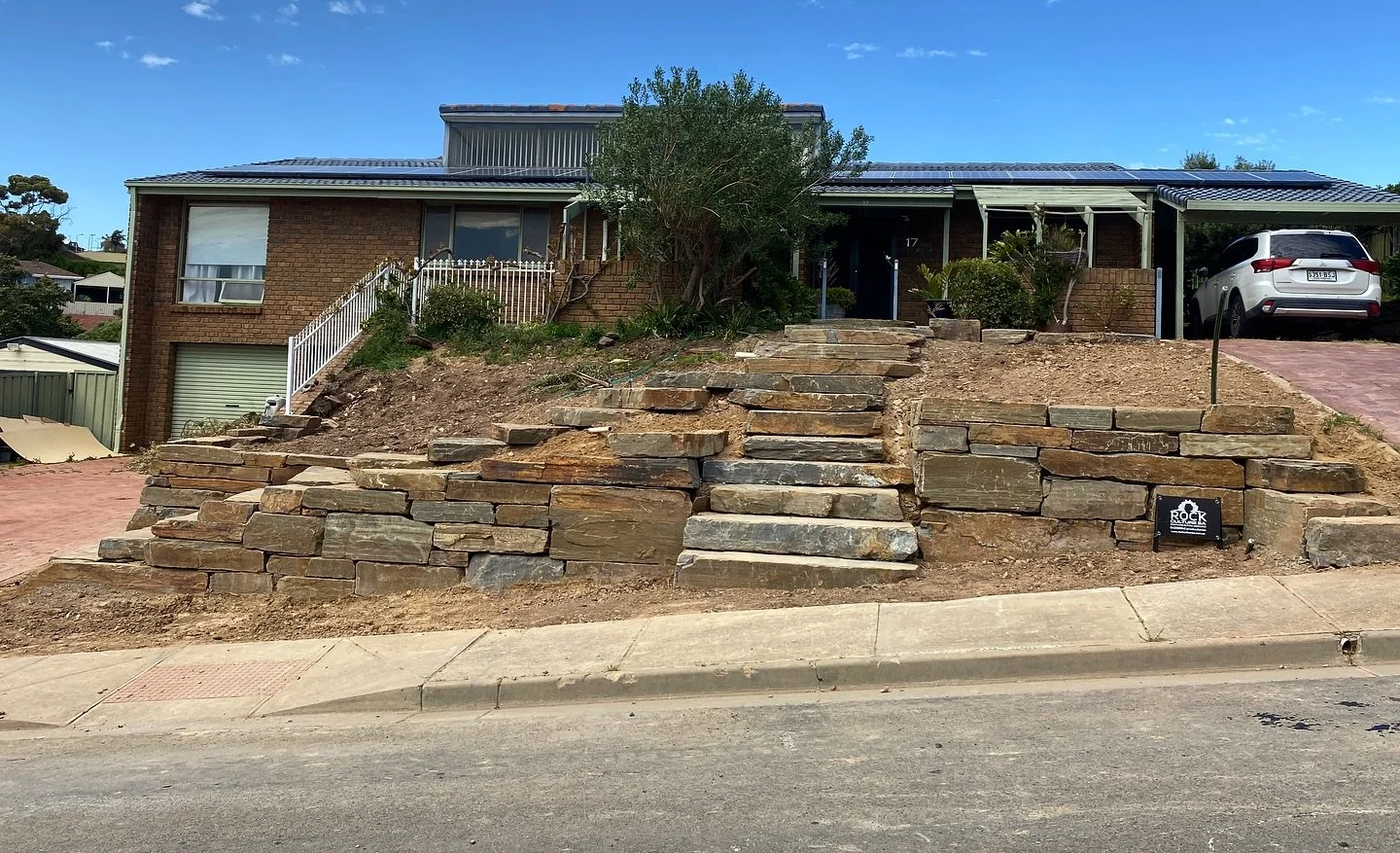 Photography is a skill I definitely need to improve on because these photos do not do this project justice. 

This B grade bluestone wall in Hallett Cove has two giant staircases that join mid way. The project is just the start of this property&rsquo