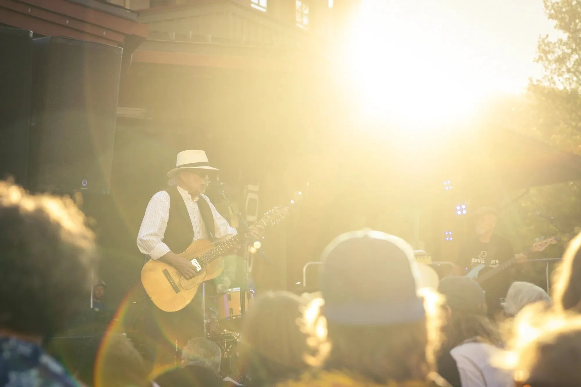 Guitarist performing live outdoors in The Village at Palisades Tahoe.